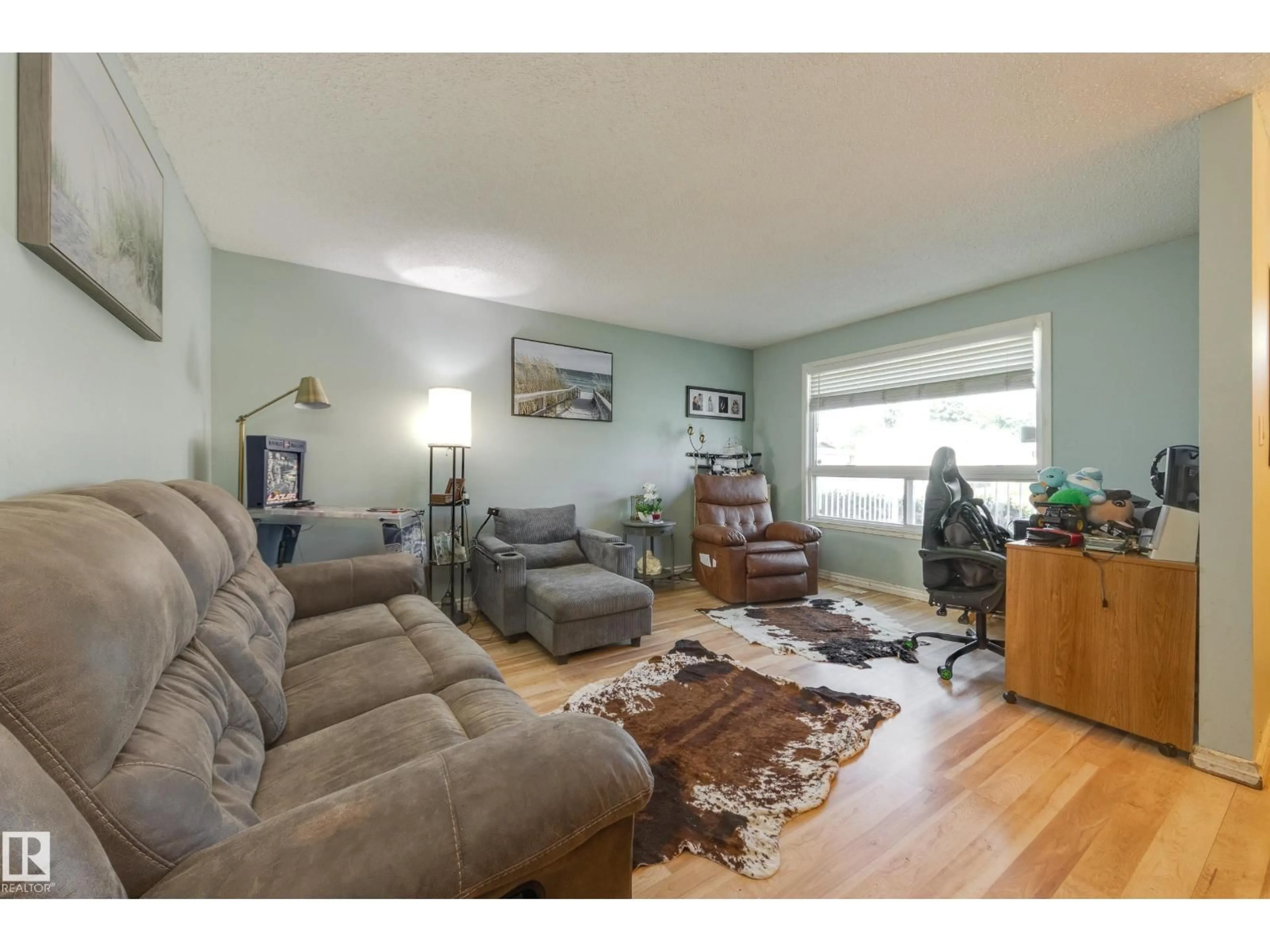 Living room with furniture, wood/laminate floor for 17328 106 ST, Edmonton Alberta T5X3G8