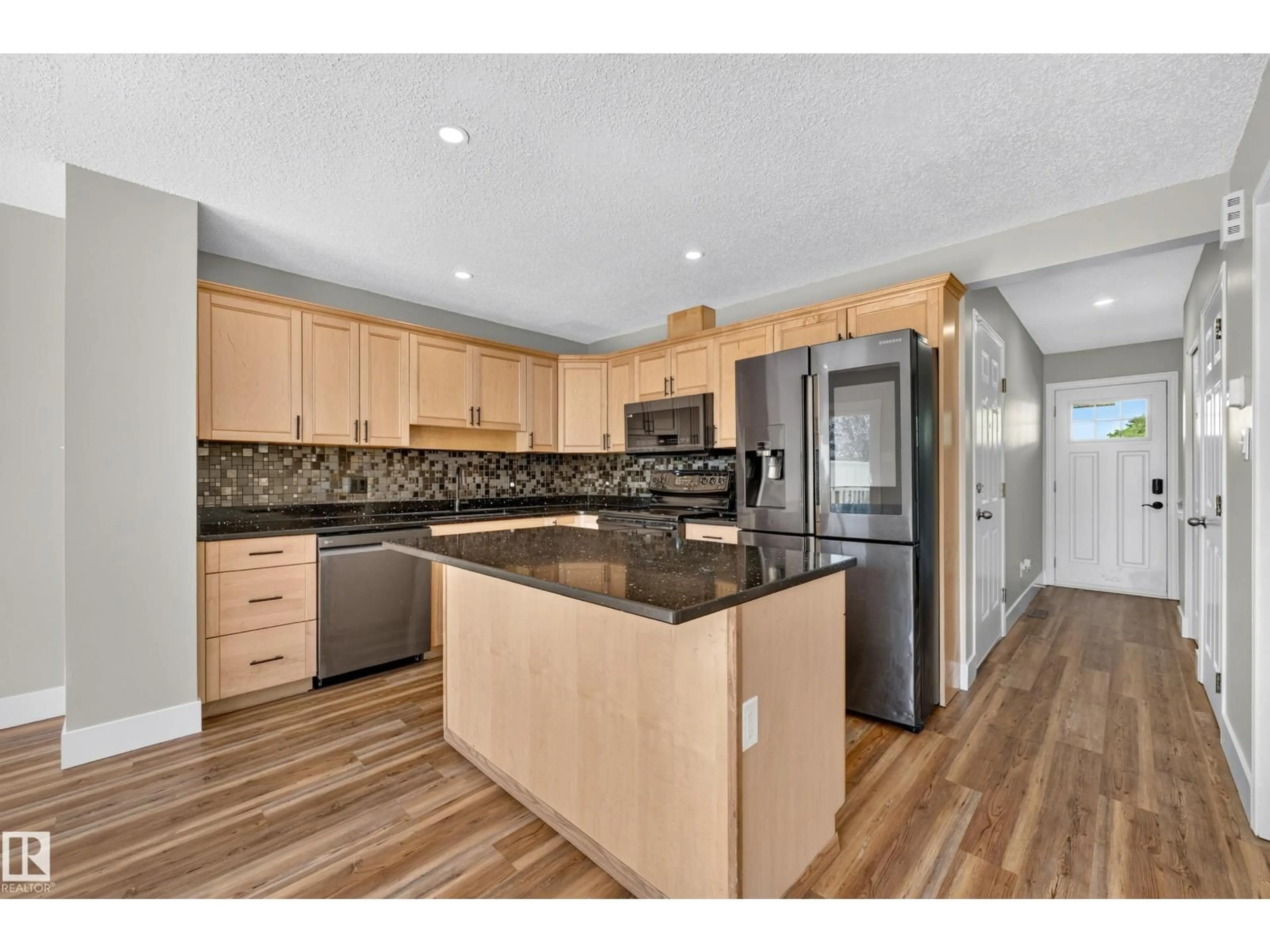 Open concept kitchen, wood/laminate floor for 13449 33 ST, Edmonton Alberta T5A5C1