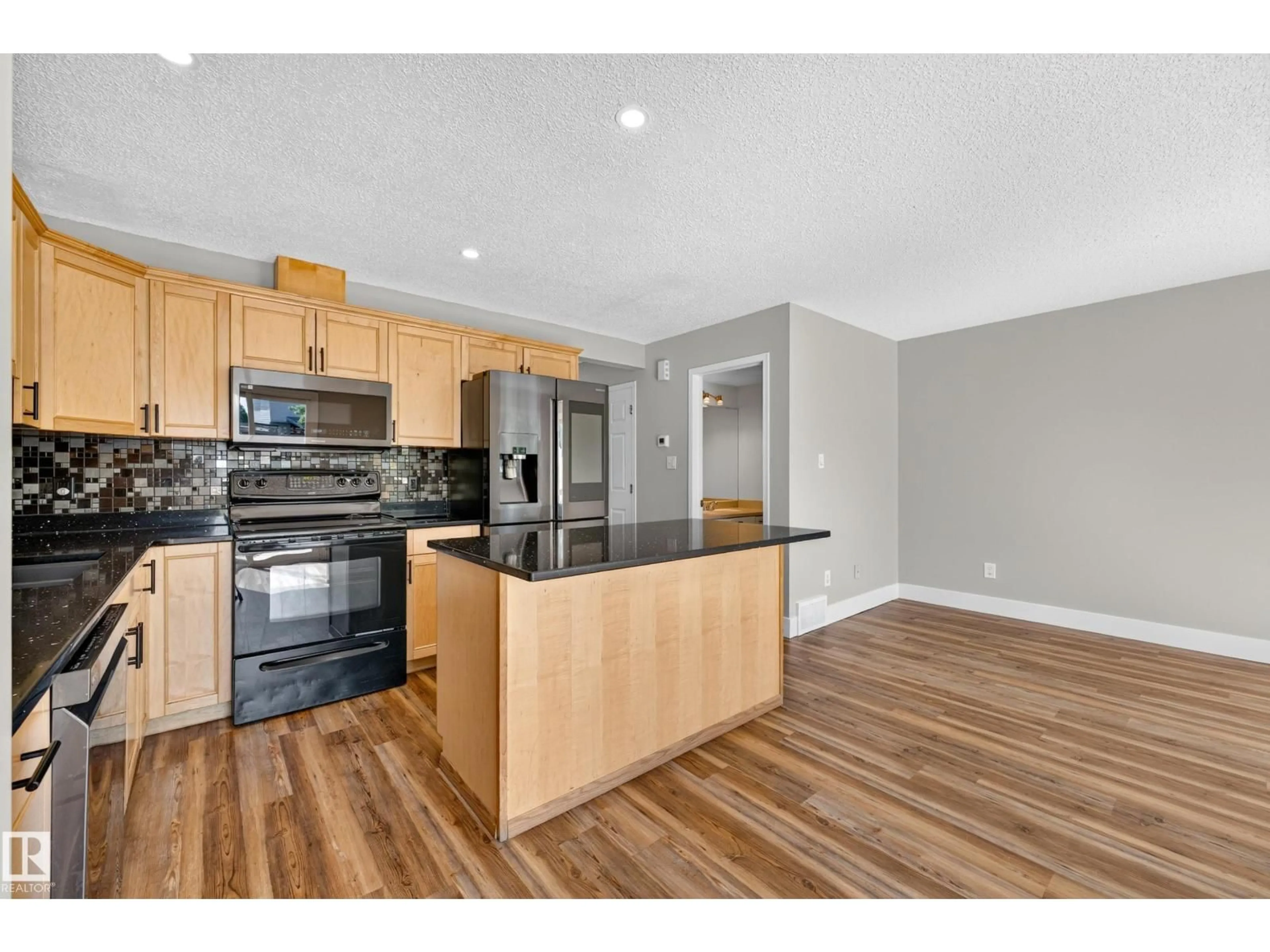 Open concept kitchen, wood/laminate floor for 13449 33 ST, Edmonton Alberta T5A5C1