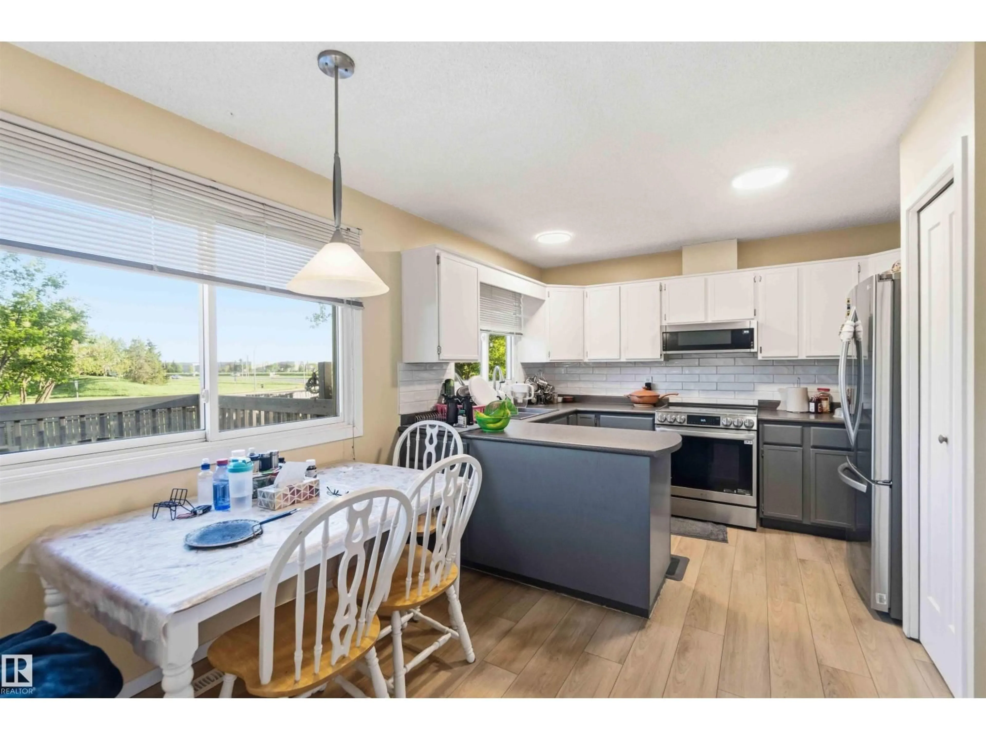 Open concept kitchen, wood/laminate floor for 8819 29 AV, Edmonton Alberta T6K2X5