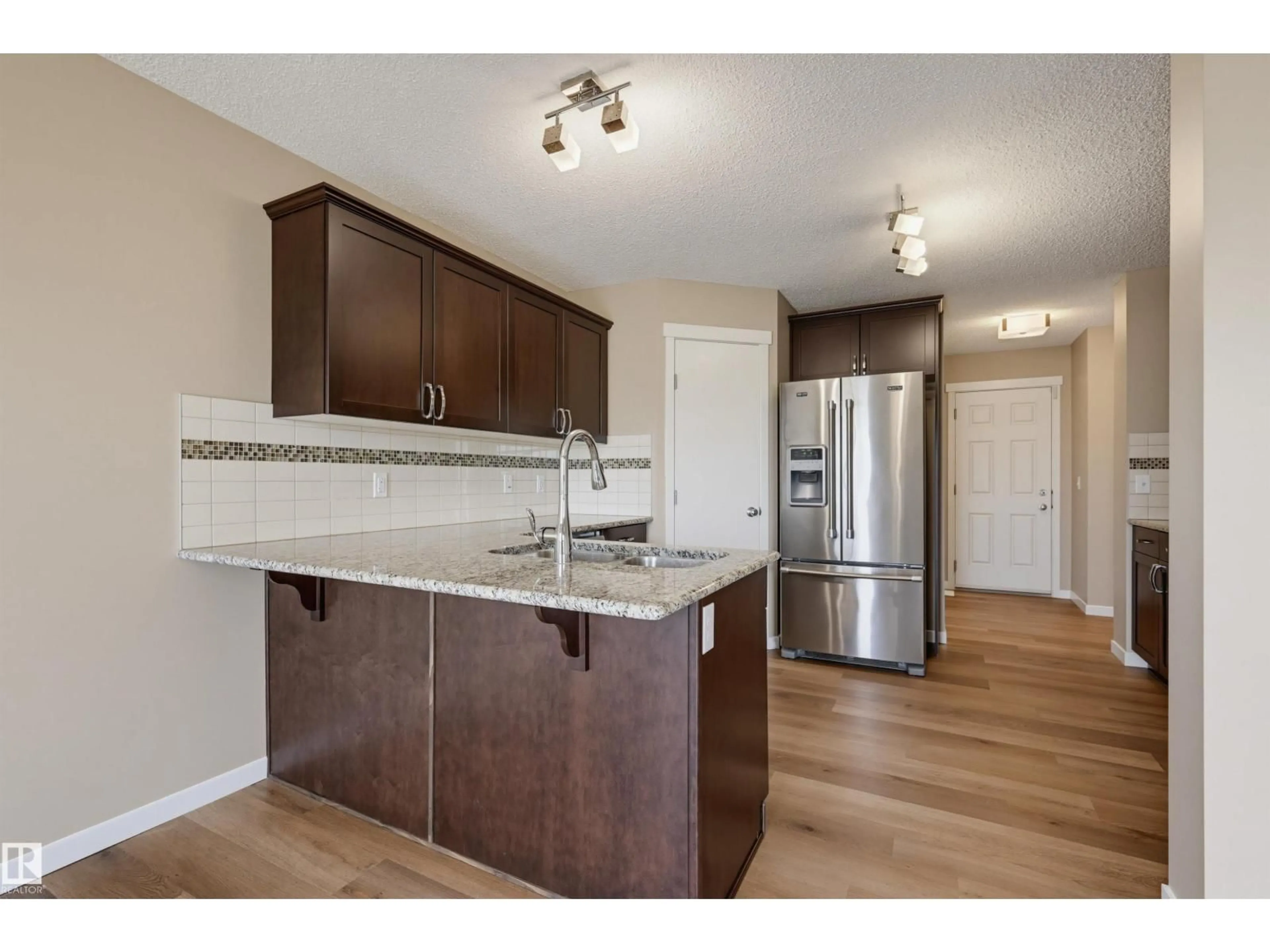 Open concept kitchen, wood/laminate floor for SW - 16428 12 AV, Edmonton Alberta T6W3K6