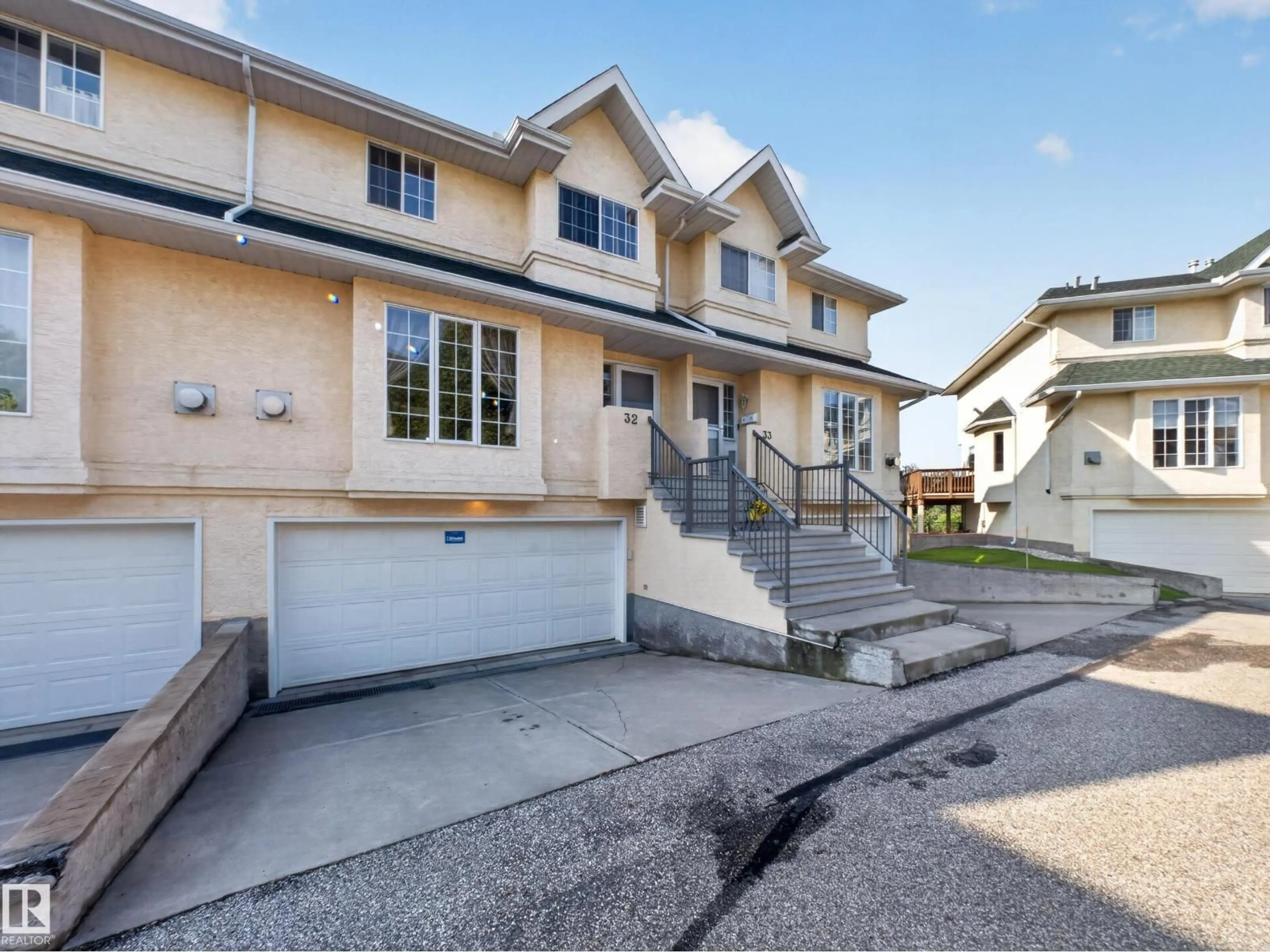Home with vinyl exterior material, street for 32 - 2419 133 AV, Edmonton Alberta T5A5A5