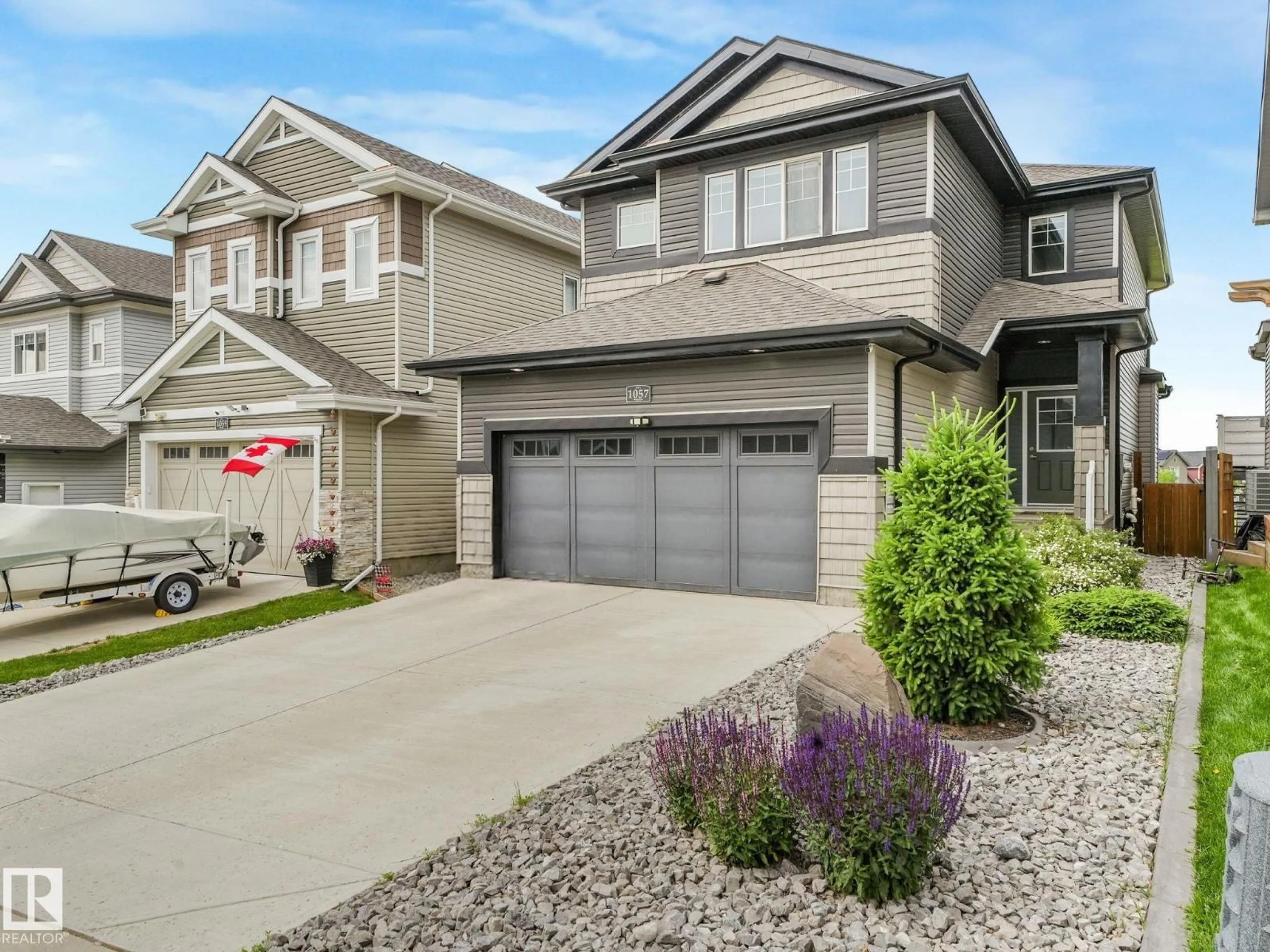 Home with vinyl exterior material, street for 1057 COOPERS HAWK LI, Edmonton Alberta T5S0M2