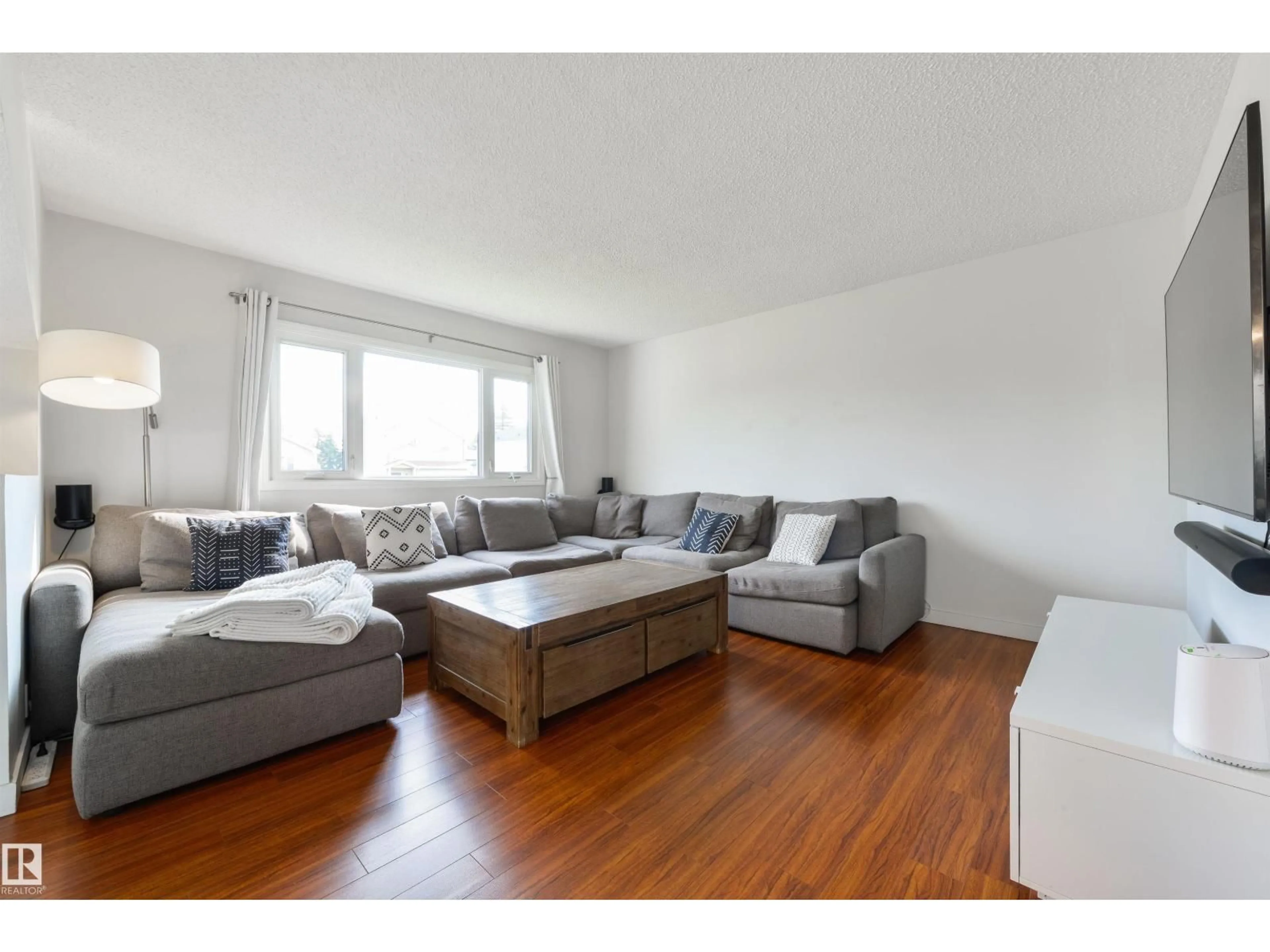 Living room with furniture, wood/laminate floor for 18423 96A AV, Edmonton Alberta T5T3N8