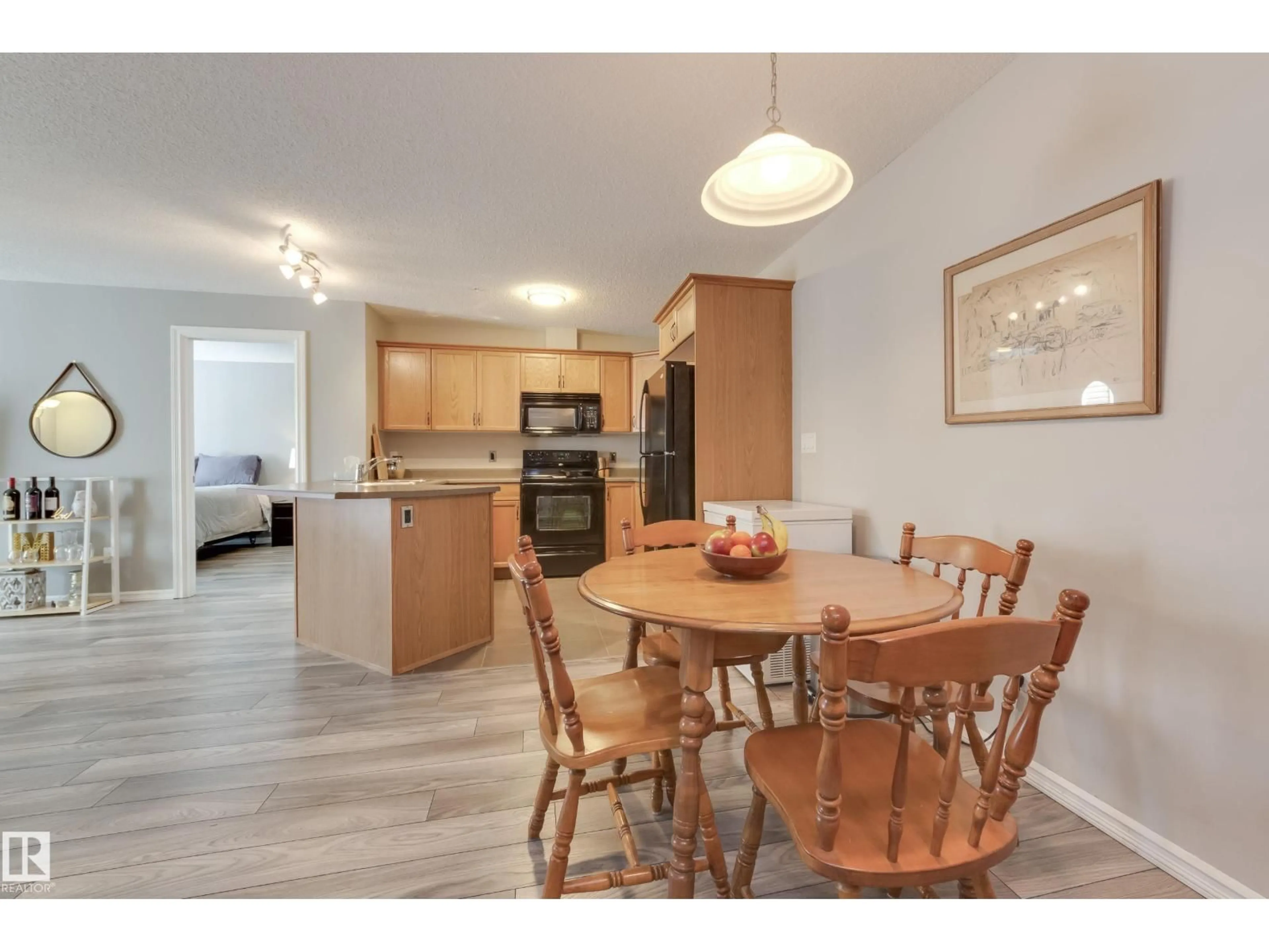 Open concept kitchen, wood/laminate floor for #213 - 4403 23 ST, Edmonton Alberta T6T0E4