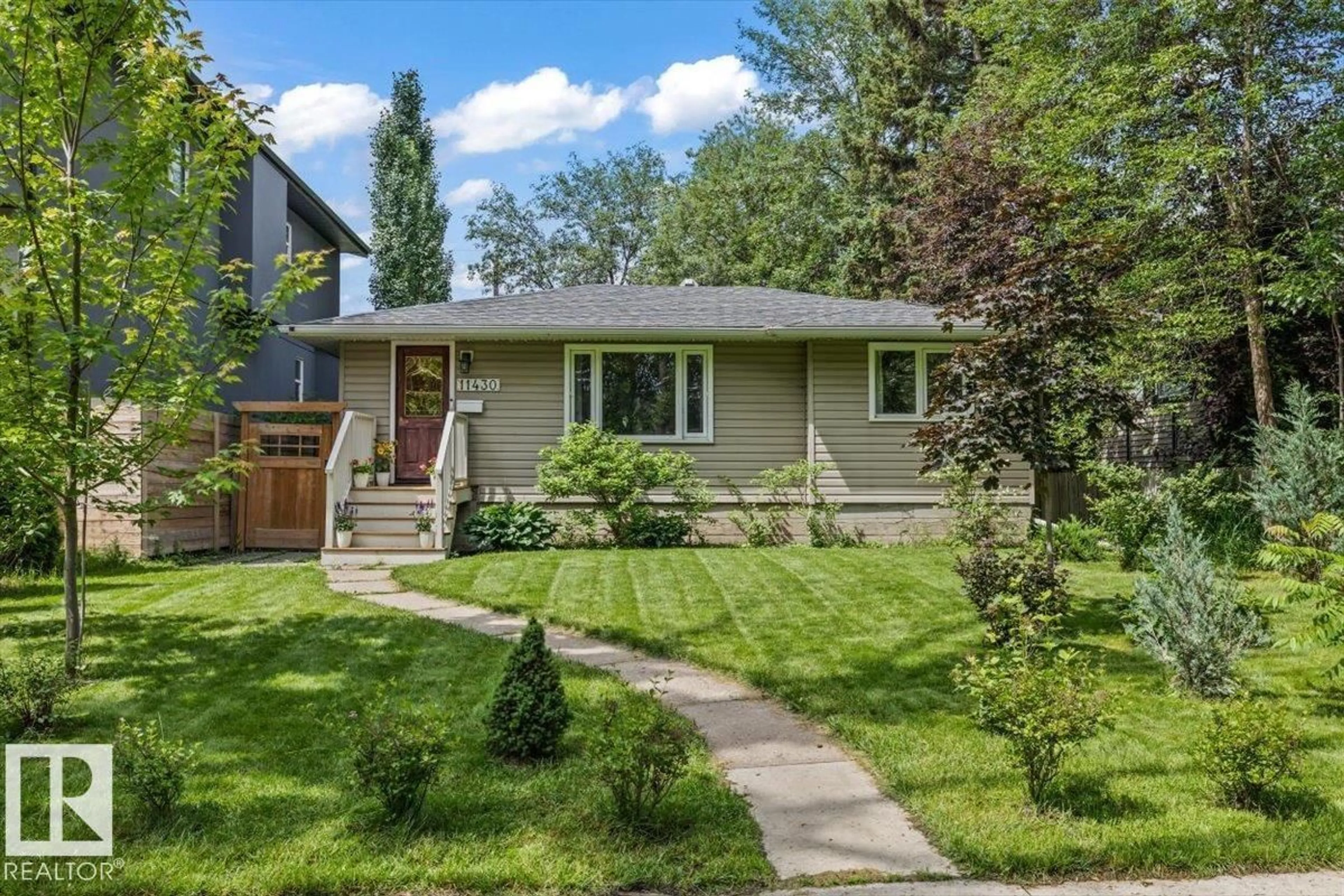 Home with vinyl exterior material, street for 11430 122 ST, Edmonton Alberta T5M0B9