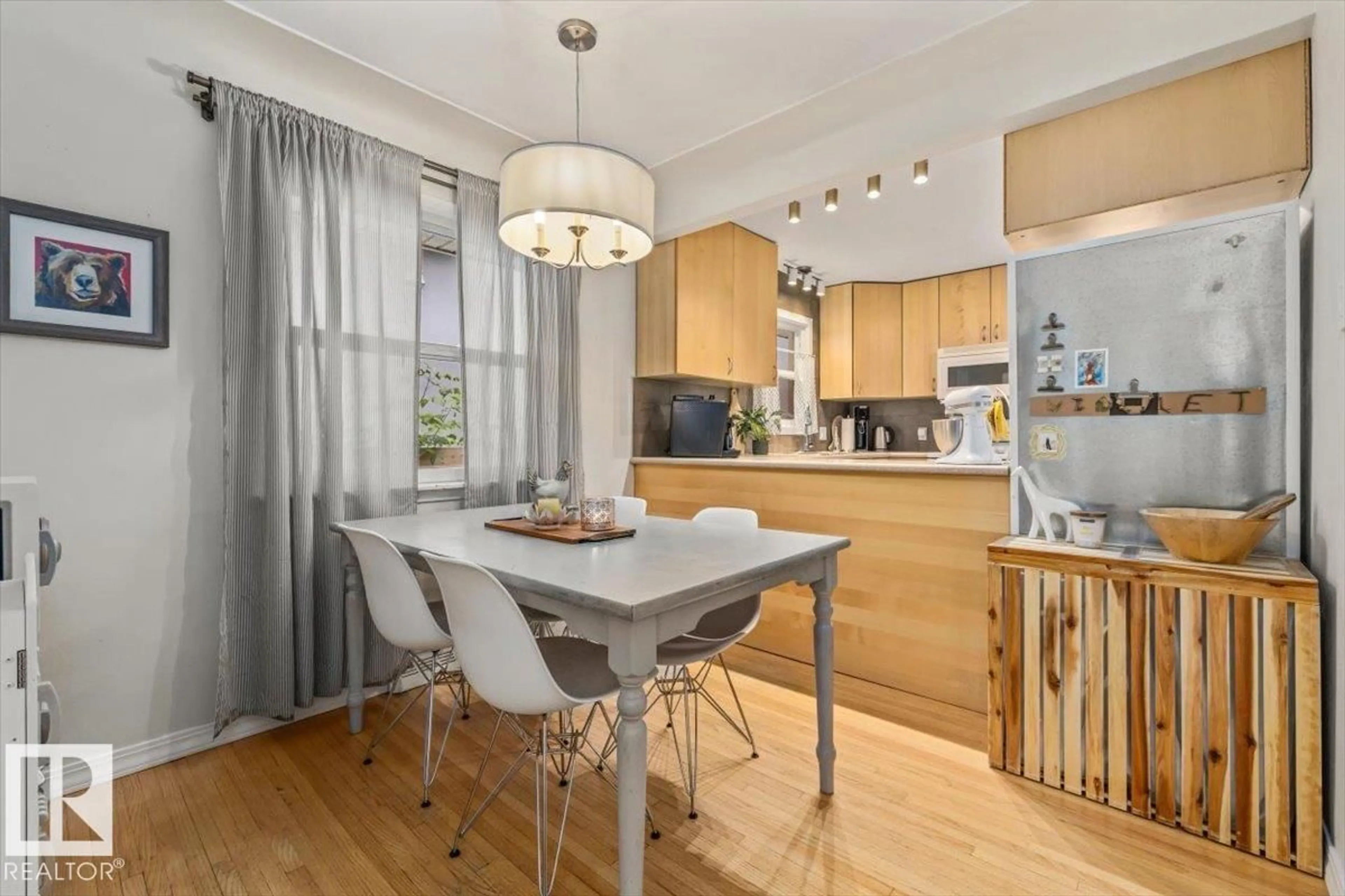 Open concept kitchen, wood/laminate floor for 11430 122 ST, Edmonton Alberta T5M0B9