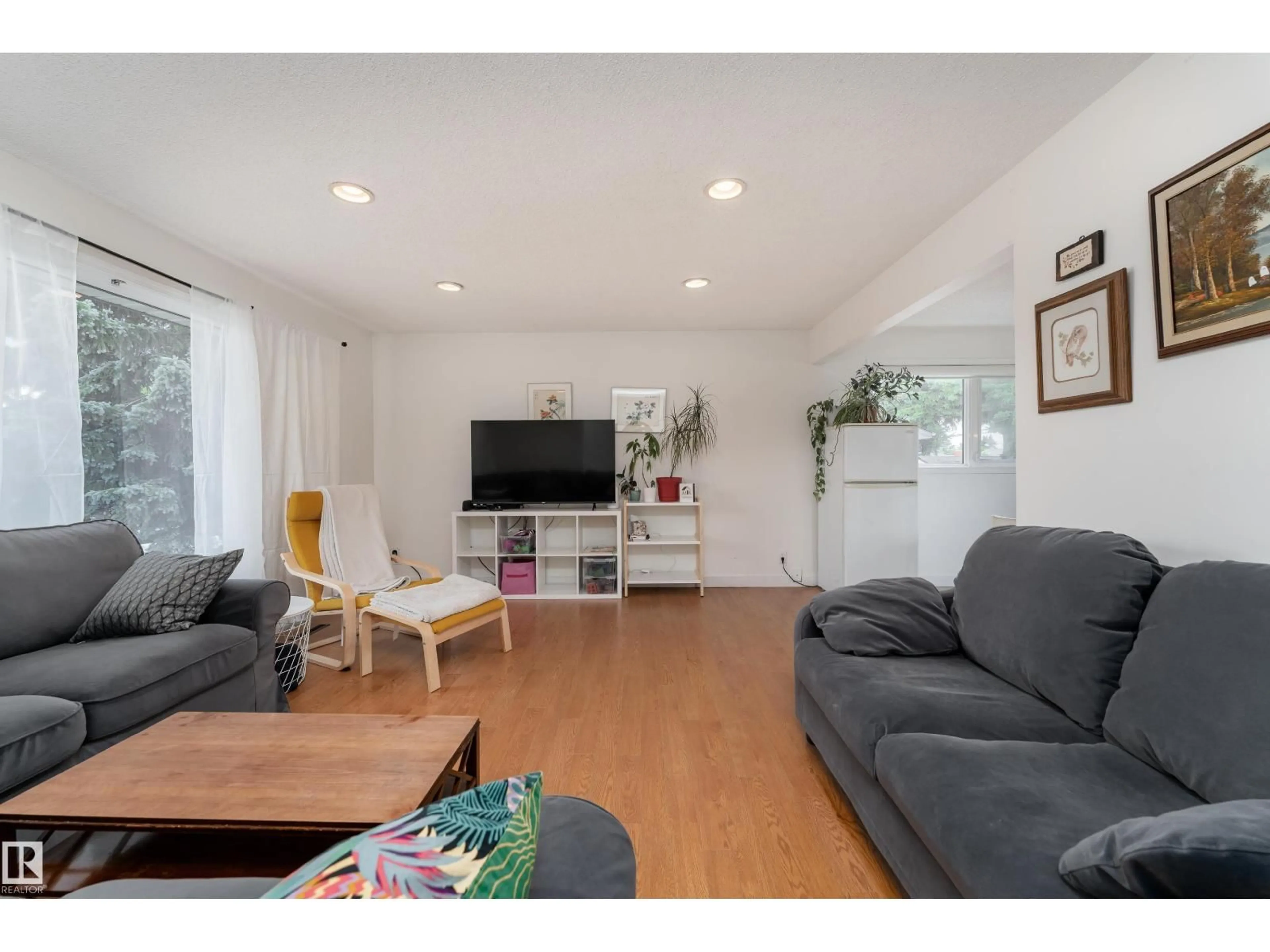 Living room with furniture, wood/laminate floor for NW - 13616 137 ST, Edmonton Alberta T5L2B3