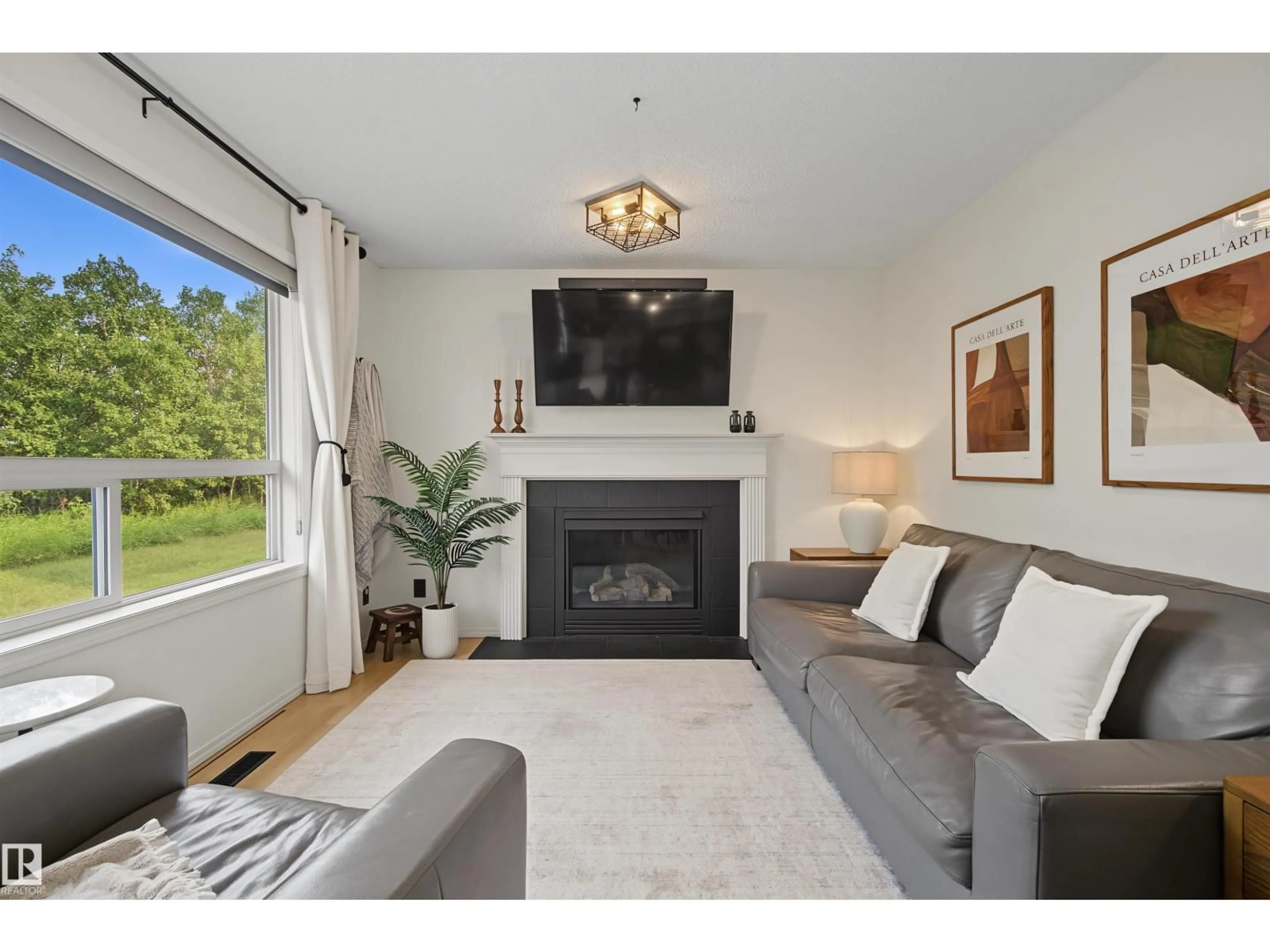 Living room with furniture, wood/laminate floor for 15 - 450 HYNDMAN CR, Edmonton Alberta T5A0E2