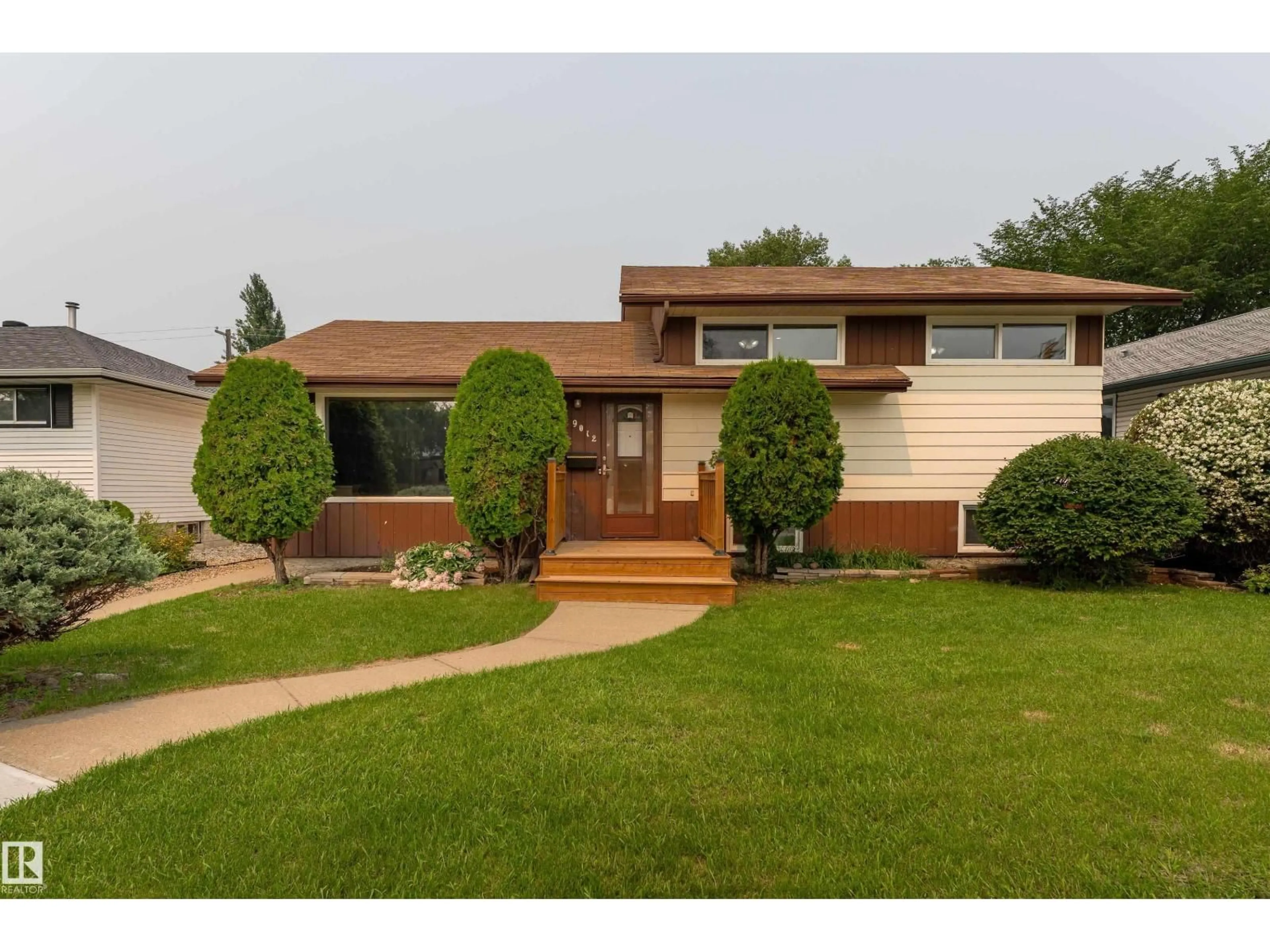Home with vinyl exterior material, street for 9012 MEADOWLARK RD, Edmonton Alberta T5R5W8