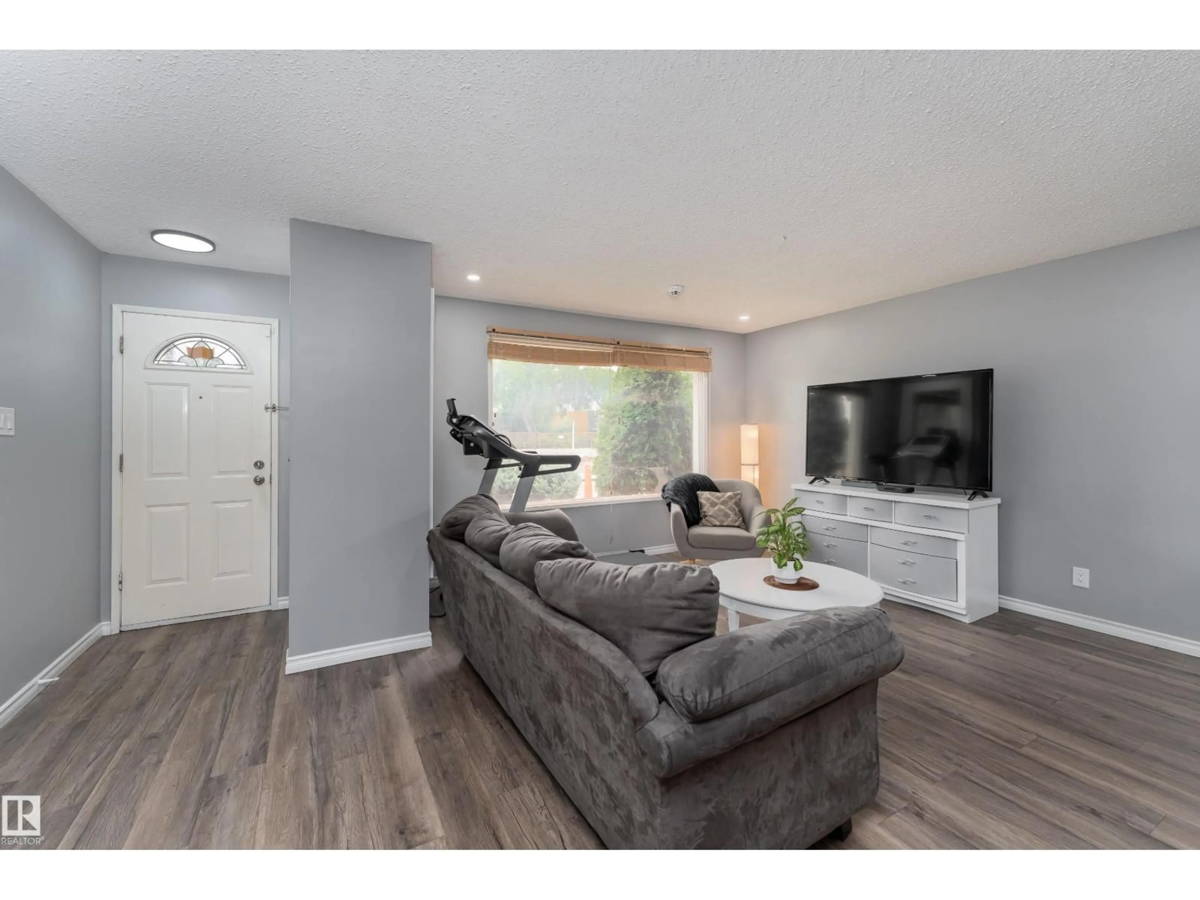 Living room with furniture, wood/laminate floor for 9012 MEADOWLARK RD, Edmonton Alberta T5R5W8