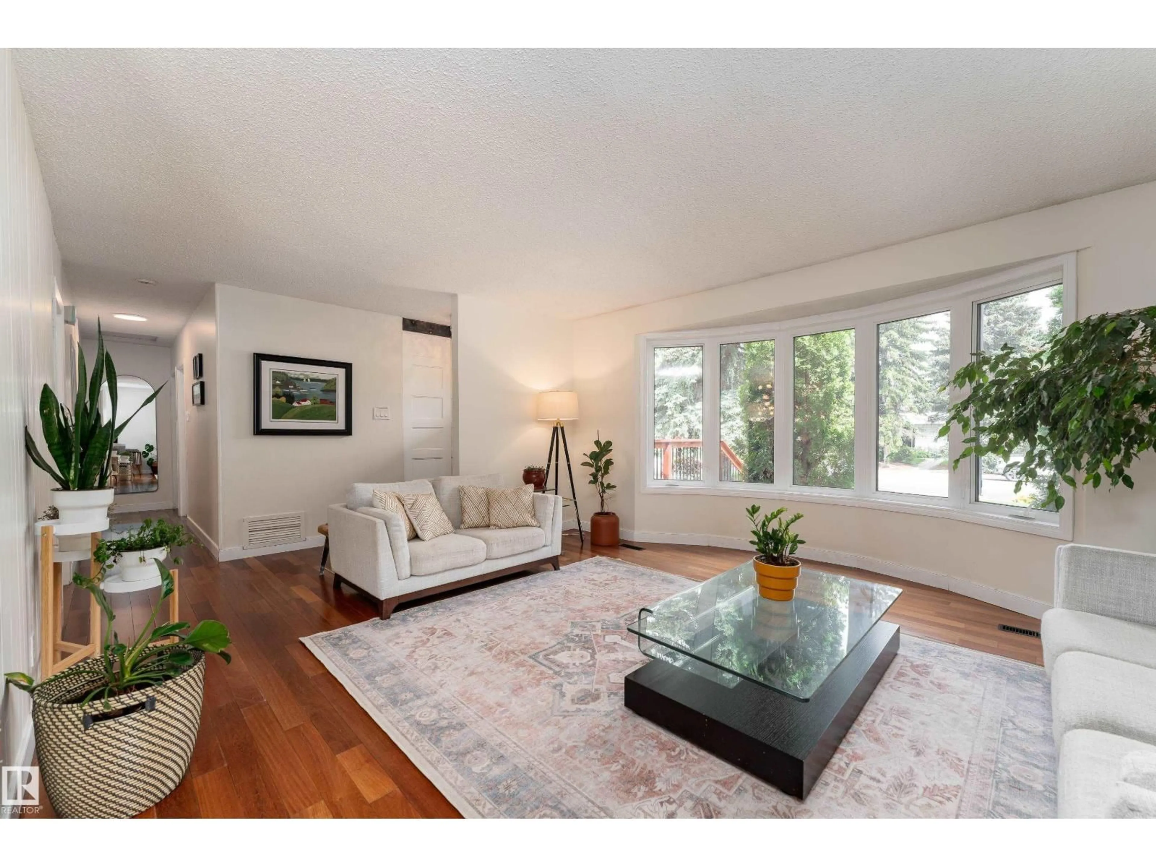 Living room with furniture, wood/laminate floor for NW - 7816 142 ST, Edmonton Alberta T5R0L8