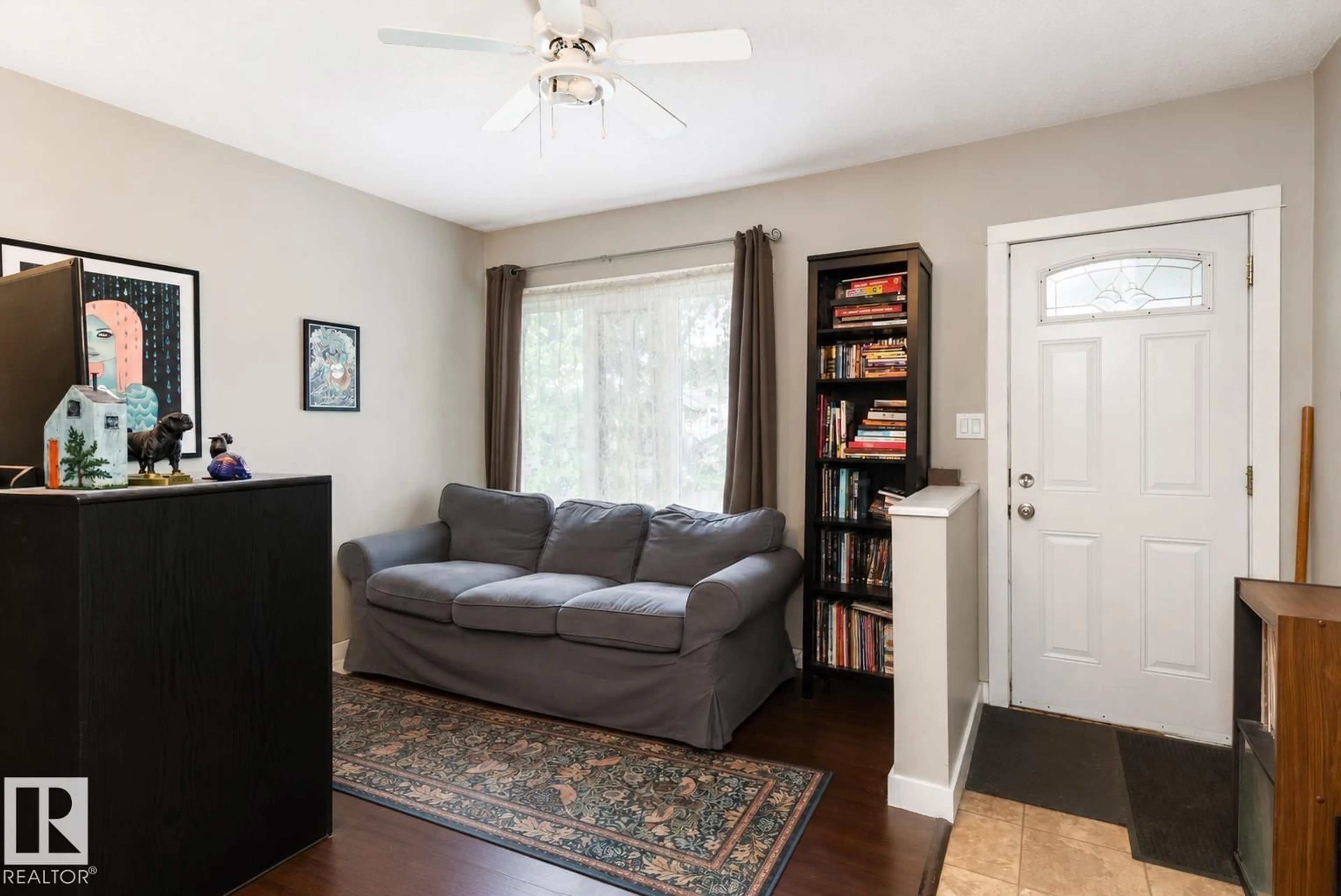 Living room with furniture, wood/laminate floor for 9631 78 AV, Edmonton Alberta T6C0P2