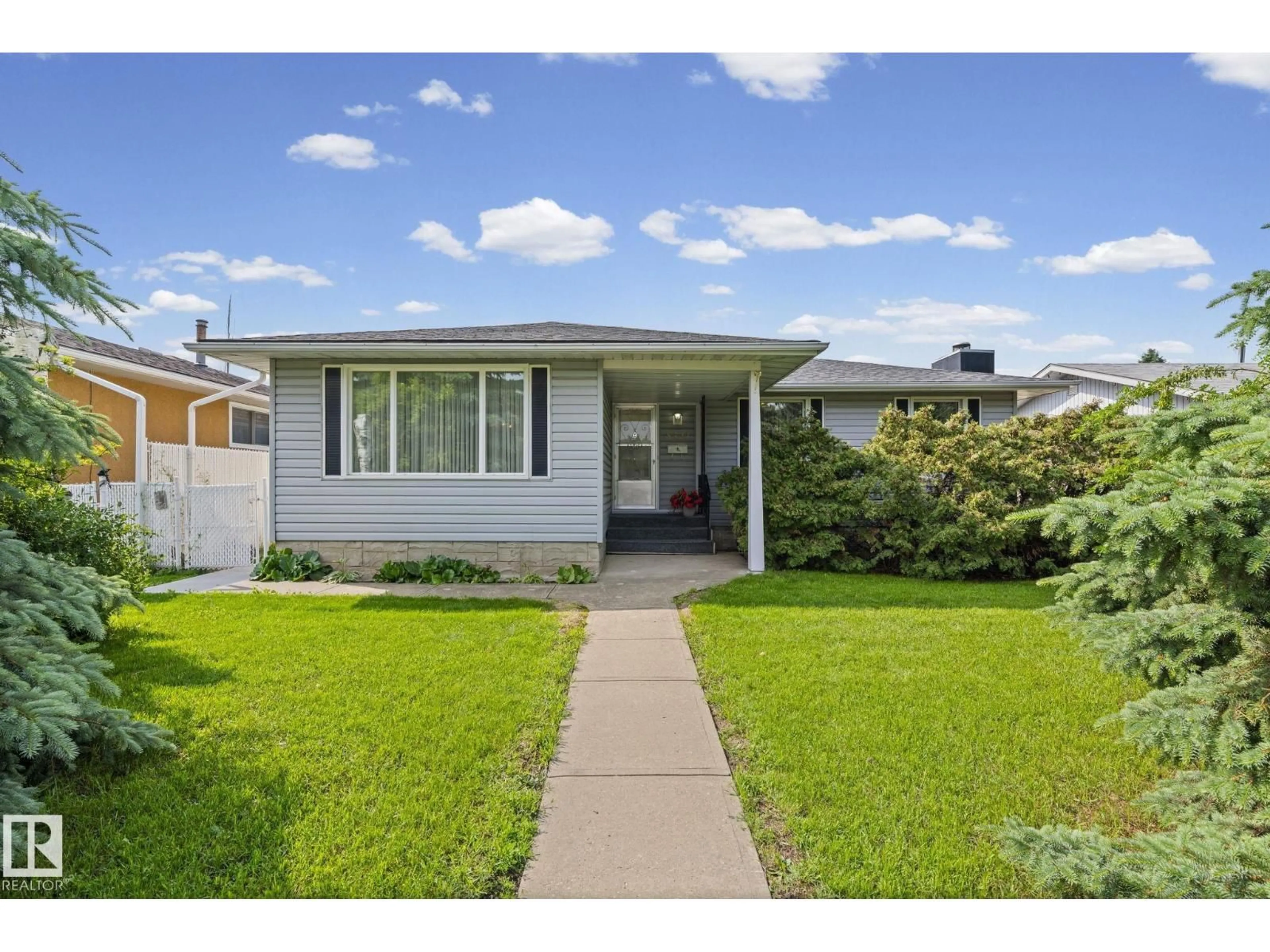 Home with vinyl exterior material, street for 8323 142 AV, Edmonton Alberta T5E2G3
