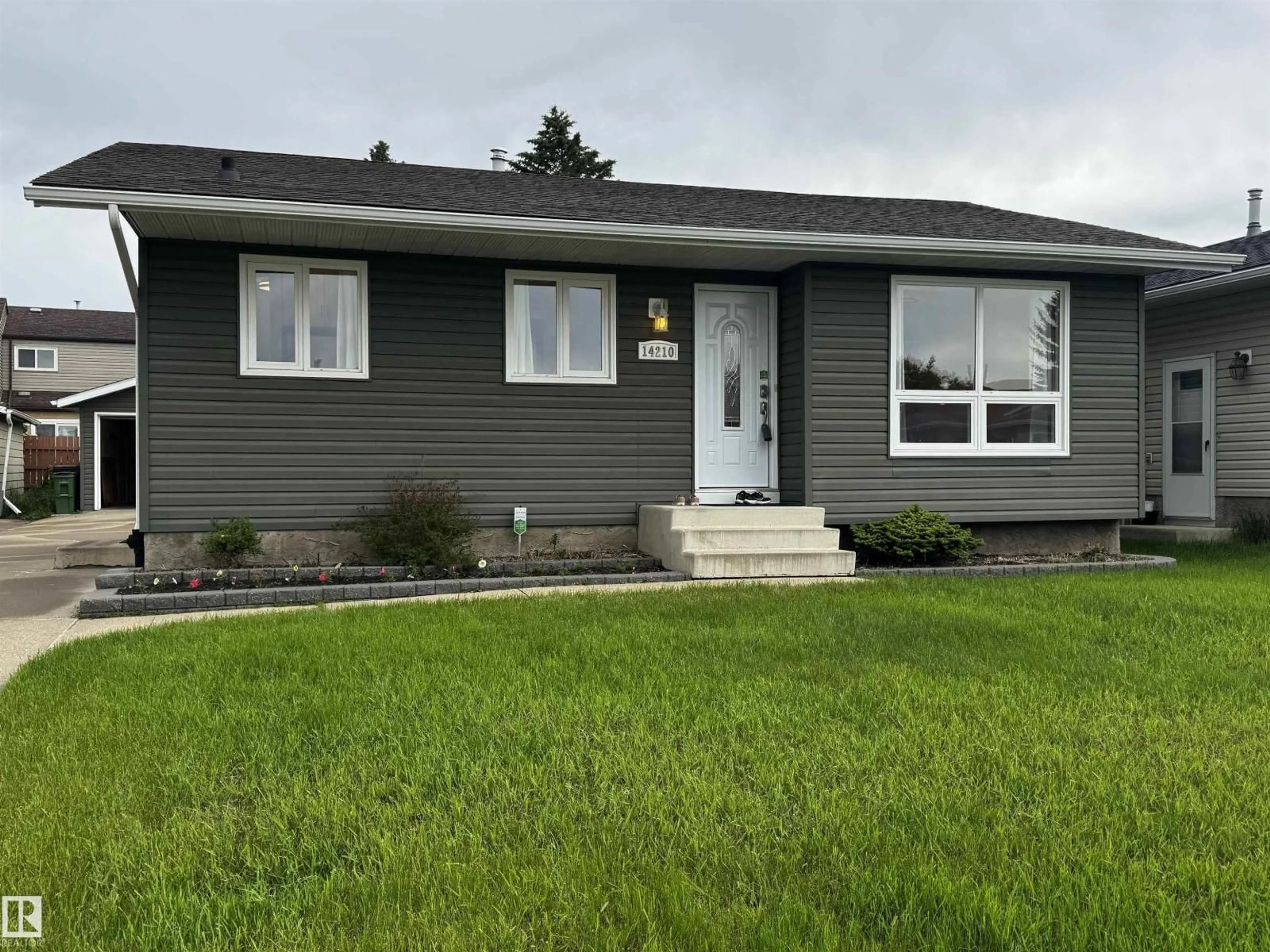 Home with vinyl exterior material, street for 14210 22A ST NW, Edmonton Alberta T5Y1E1