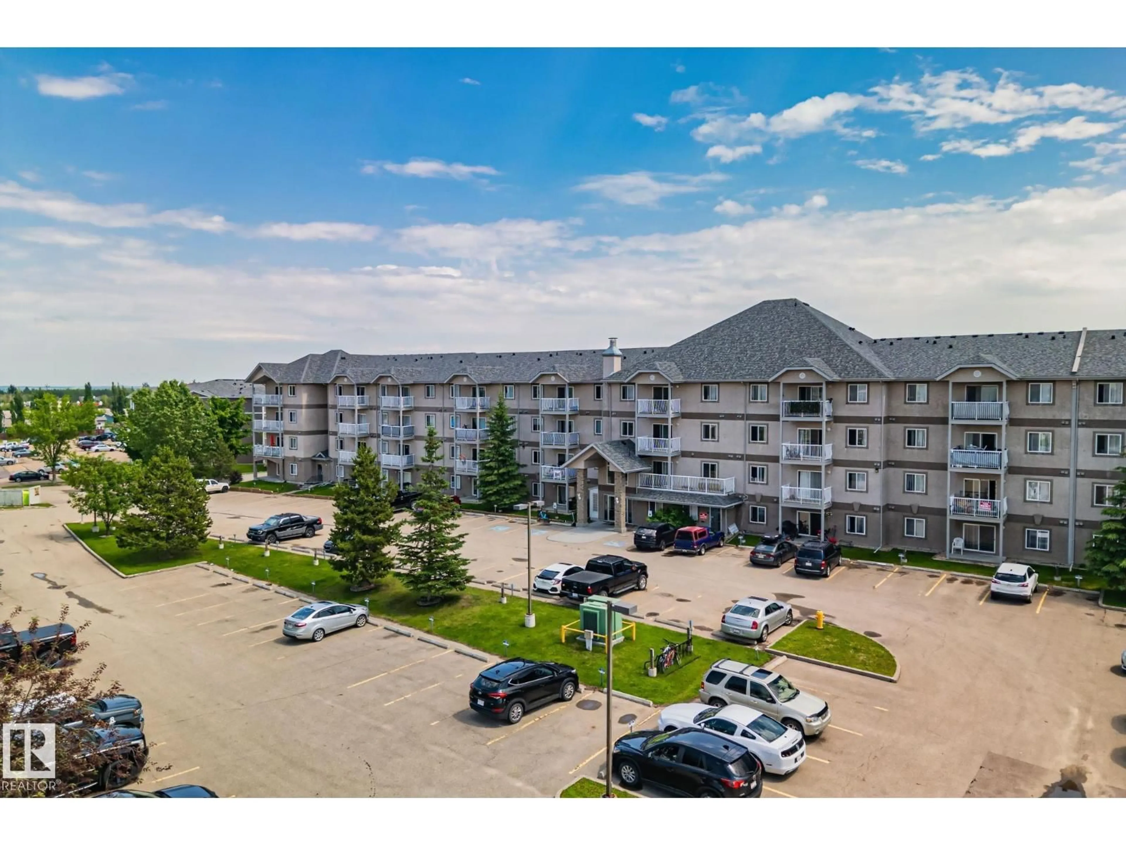 A pic from outside/outdoor area/front of a property/back of a property/a pic from drone, mountain view for #209 - 240 SPRUCE RIDGE RD, Spruce Grove Alberta T7X0G5