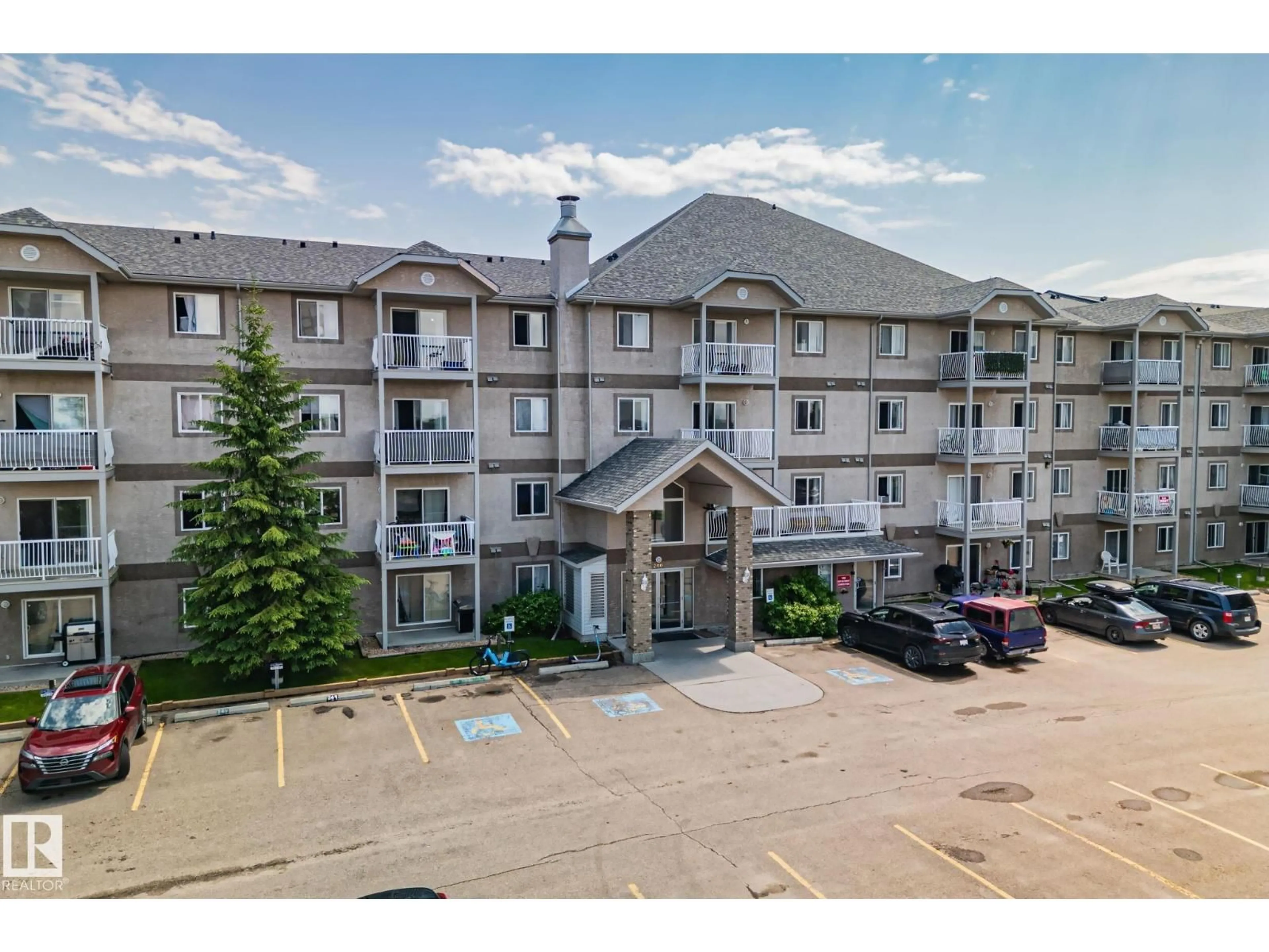 A pic from outside/outdoor area/front of a property/back of a property/a pic from drone, mountain view for #209 - 240 SPRUCE RIDGE RD, Spruce Grove Alberta T7X0G5