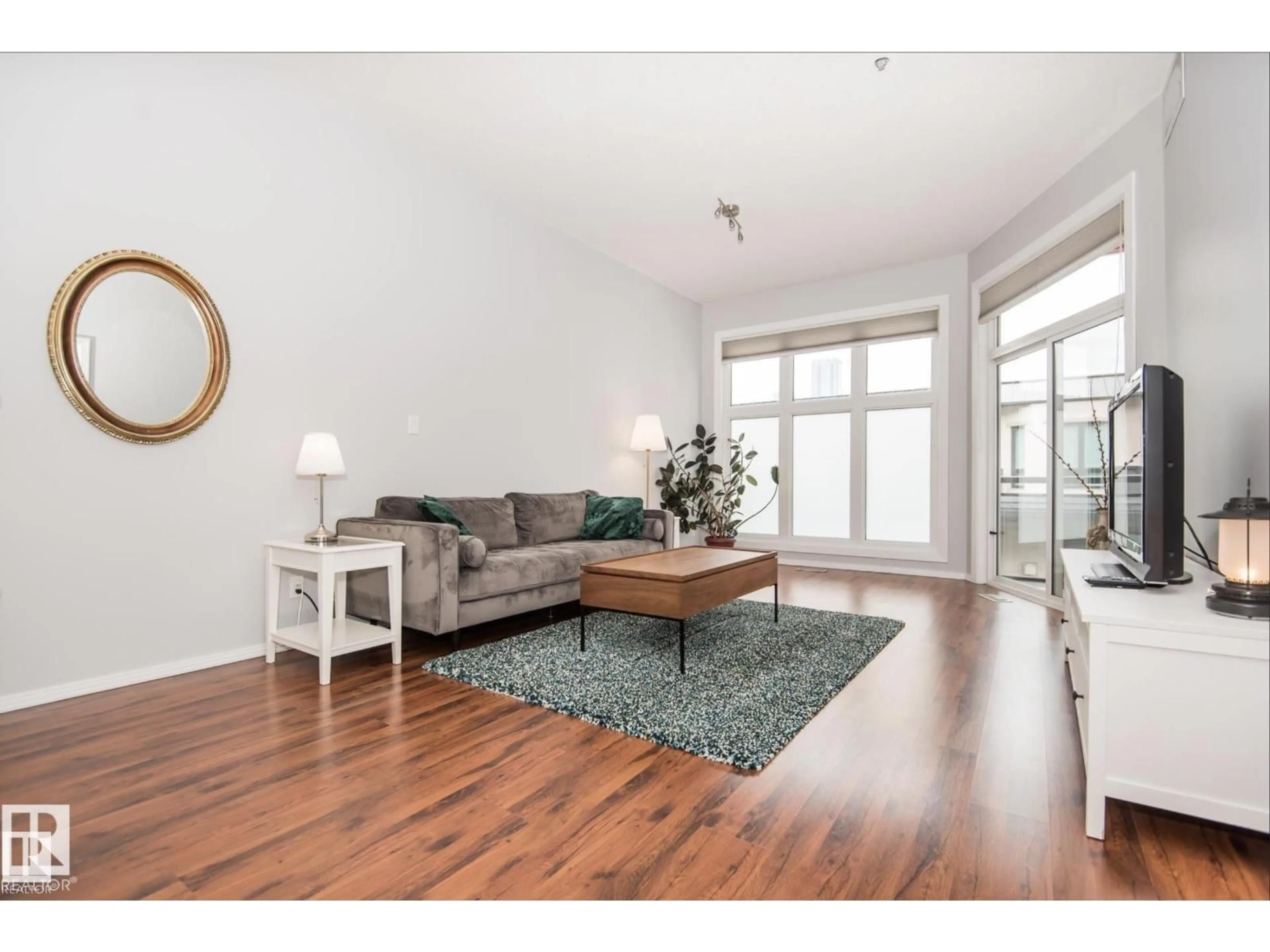 Living room with furniture, wood/laminate floor for 415 10147 112 ST NW, Edmonton Alberta T5K1M1