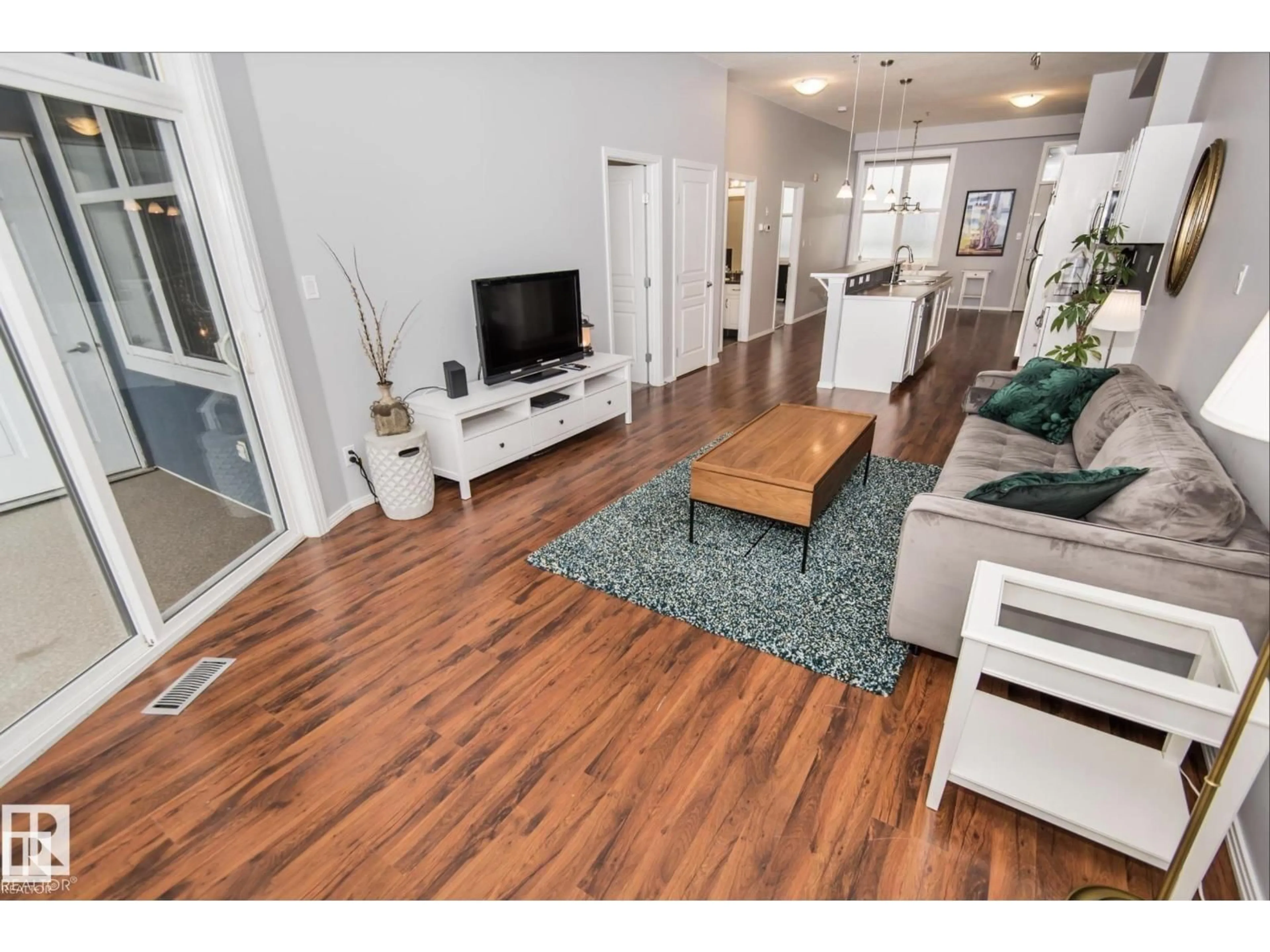 Living room with furniture, wood/laminate floor for 415 10147 112 ST NW, Edmonton Alberta T5K1M1