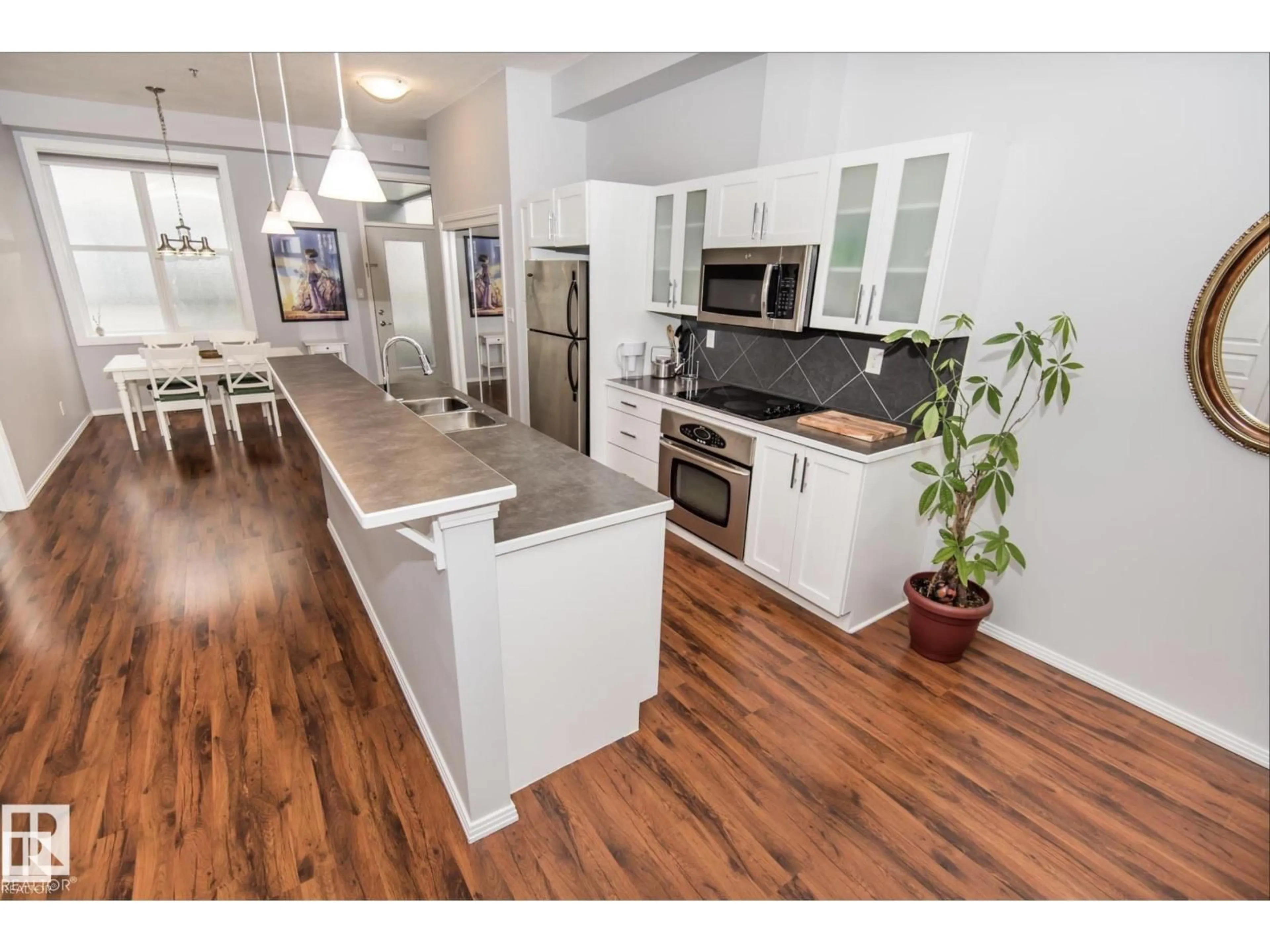Open concept kitchen, wood/laminate floor for 415 10147 112 ST NW, Edmonton Alberta T5K1M1