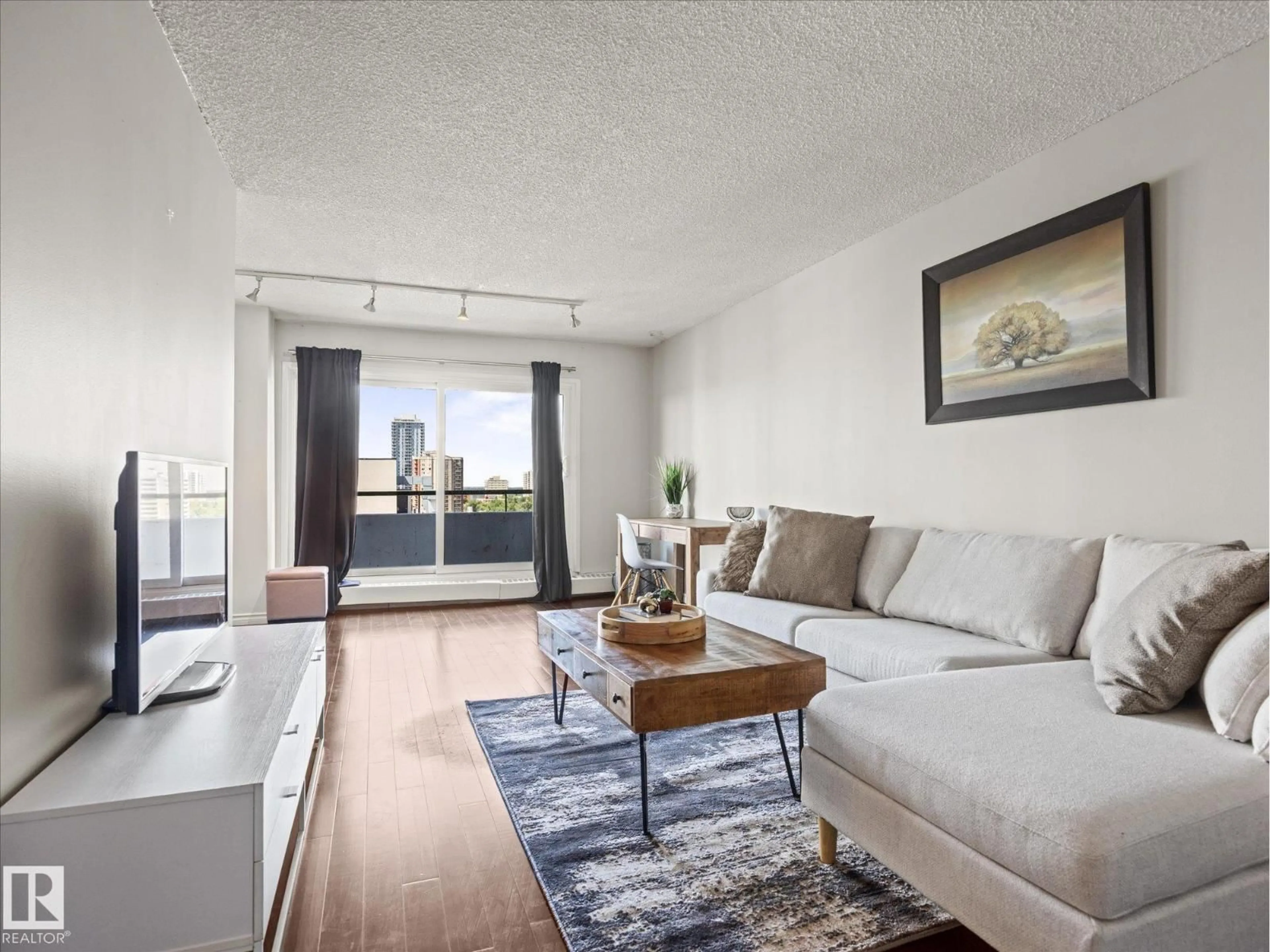 Living room with furniture, wood/laminate floor for #1601 - 9725 106 ST, Edmonton Alberta T5K1B5