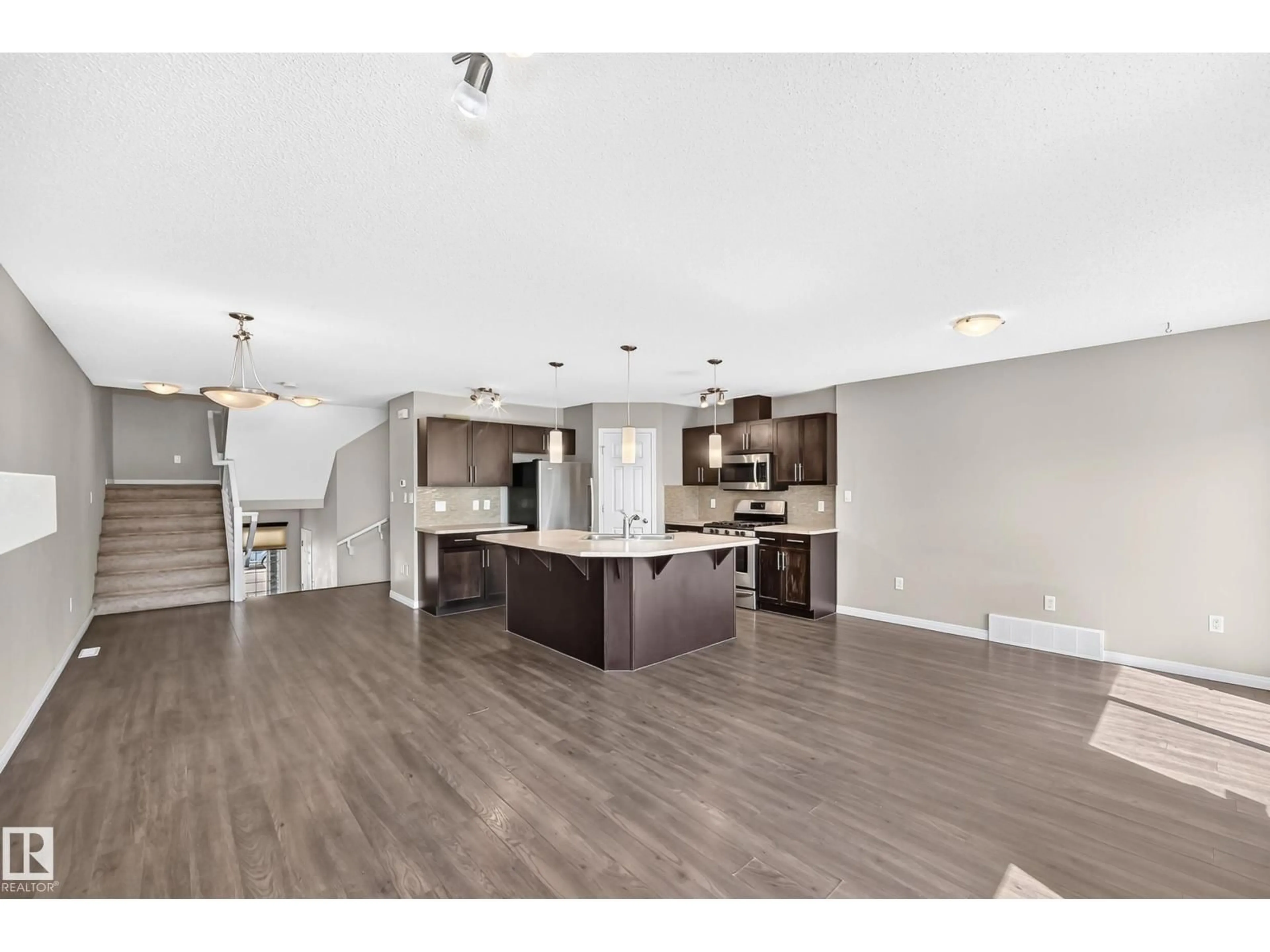 Open concept kitchen, wood/laminate floor for 1941 CHAPMAN RD, Edmonton Alberta T6W0Y7