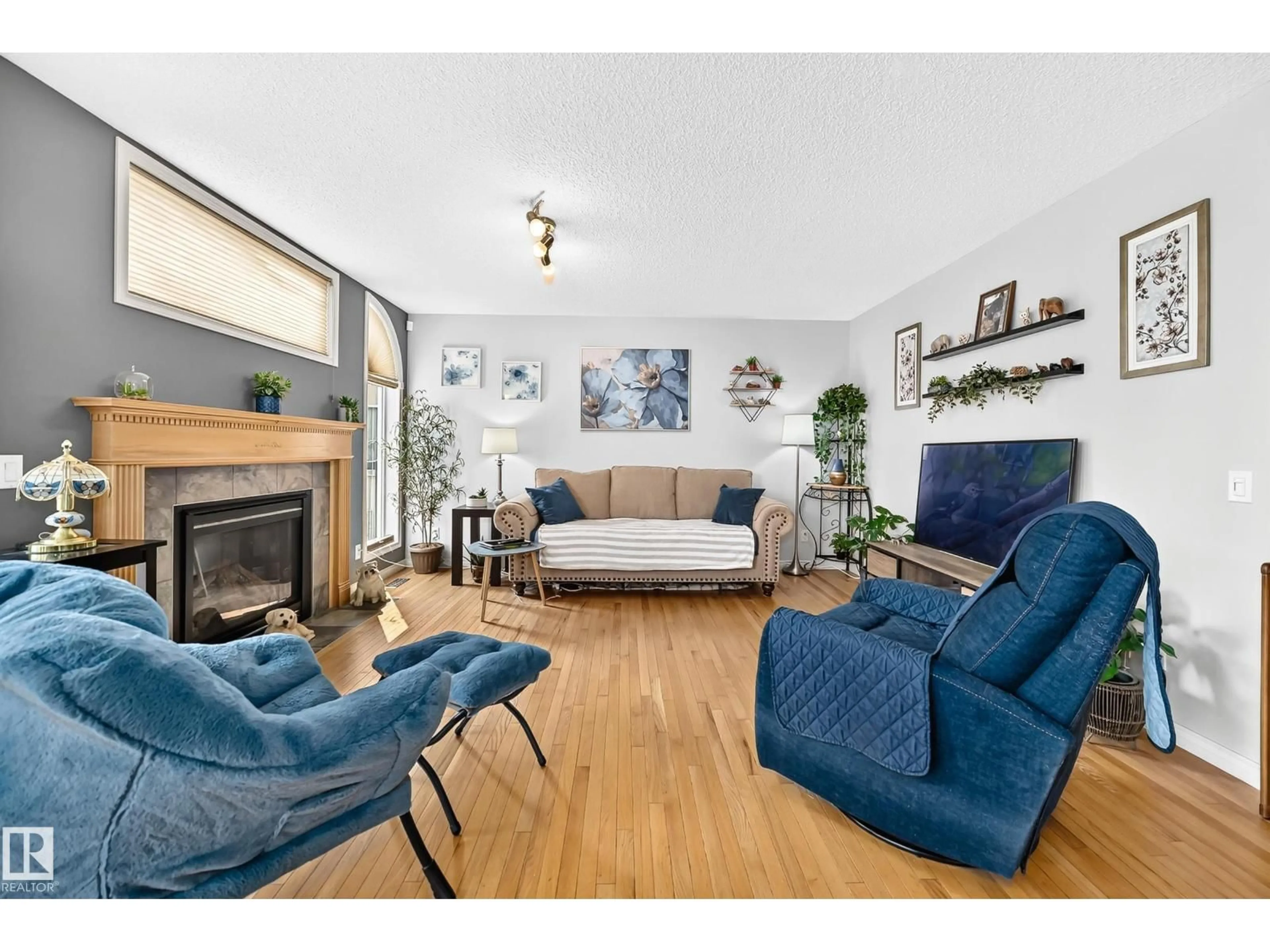 Living room with furniture, wood/laminate floor for 8507 179 AV, Edmonton Alberta T5Z0C1