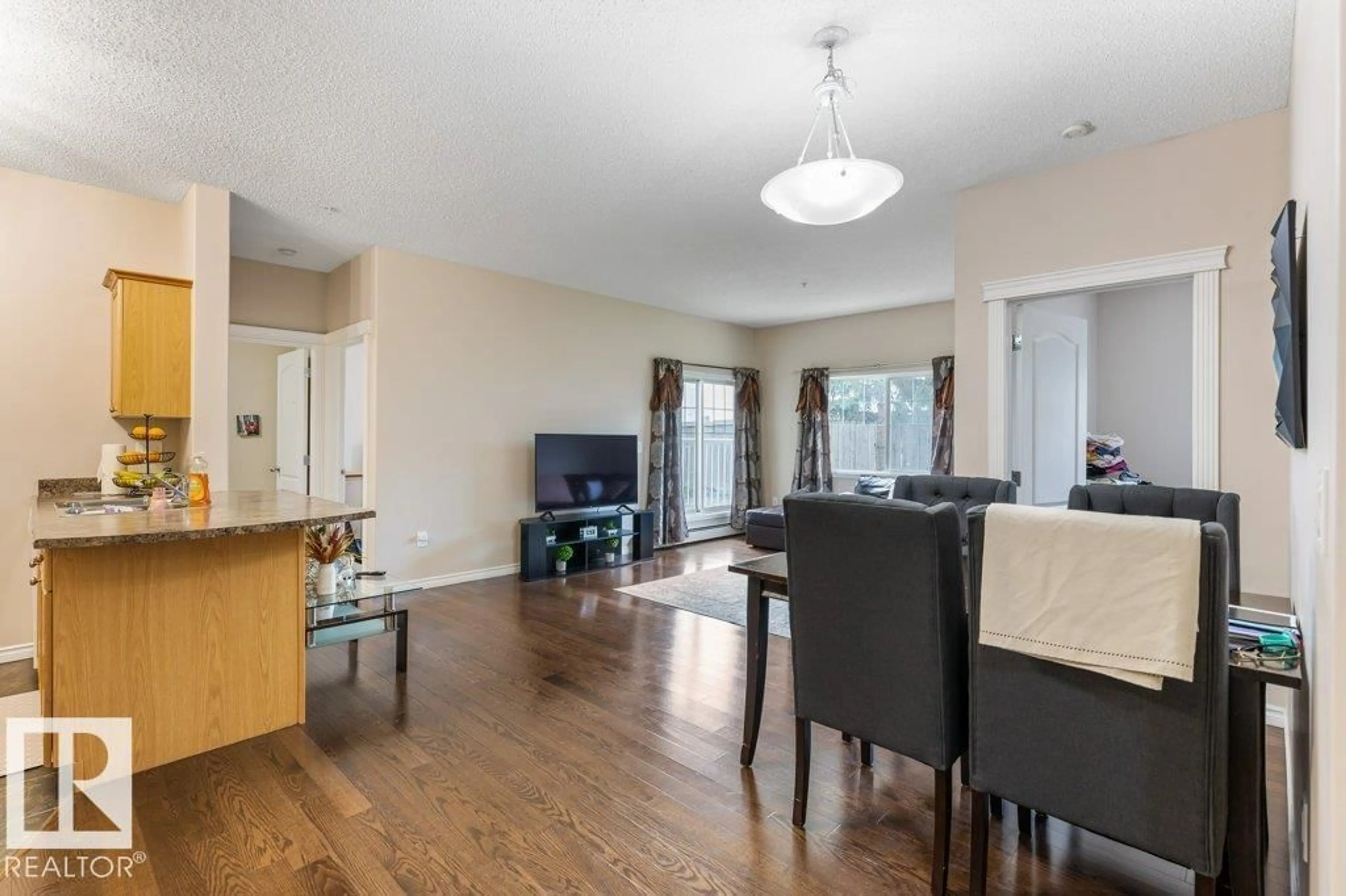 Living room with furniture, wood/laminate floor for 135 - 16807 100 AV, Edmonton Alberta T5P4Z6