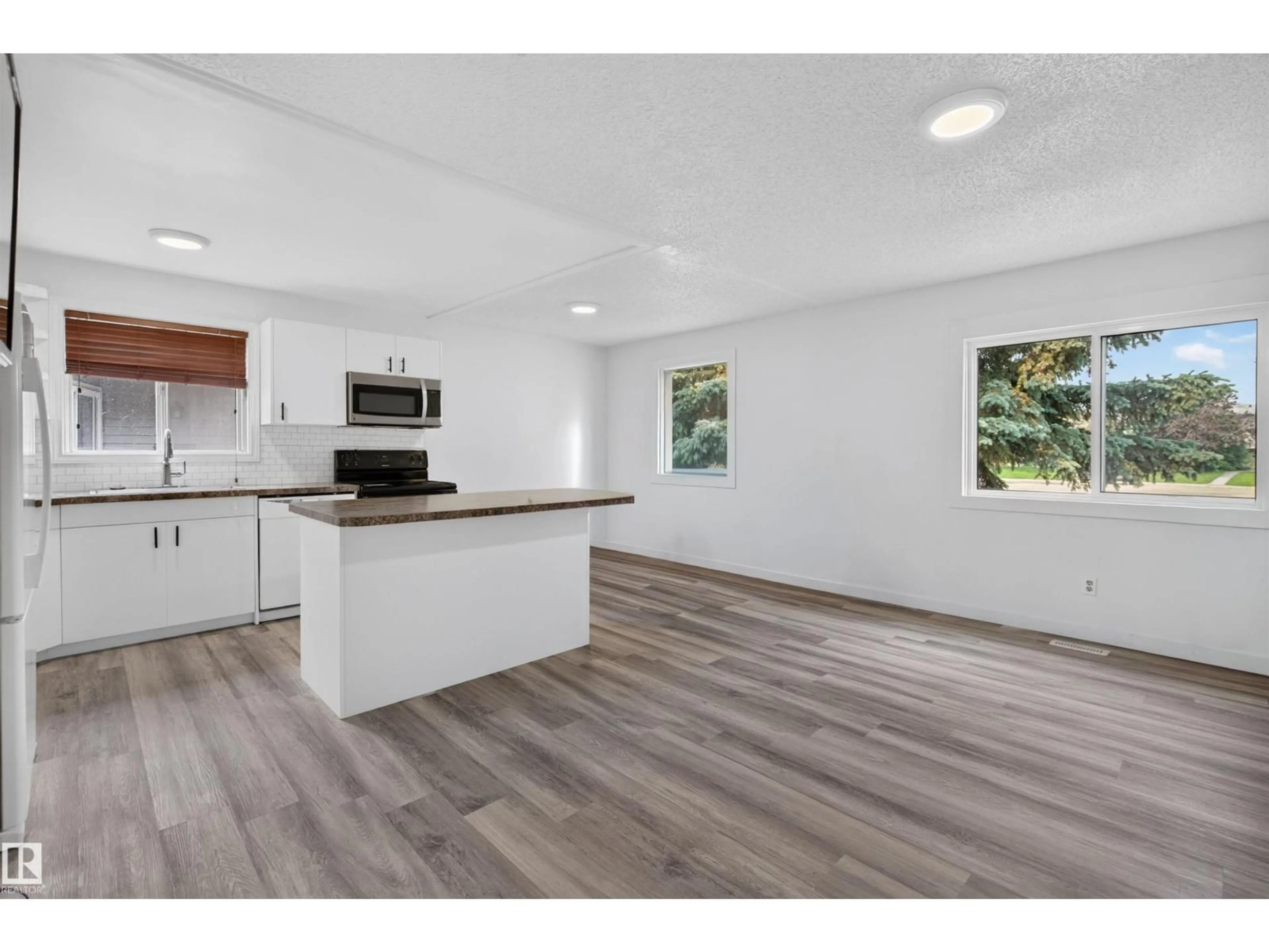 Open concept kitchen, wood/laminate floor for 27 KINISKI CR, Edmonton Alberta T6L5E3