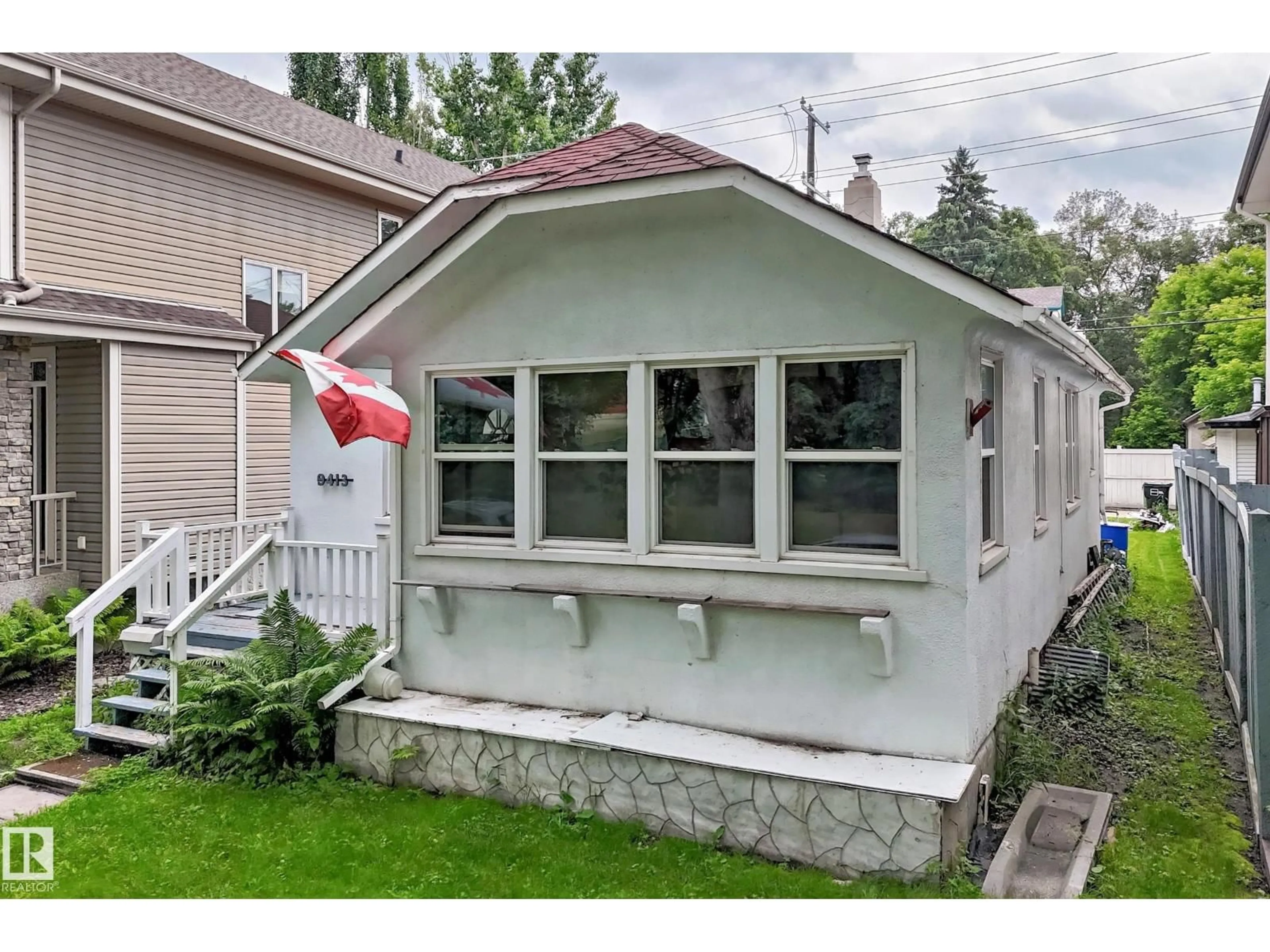 Home with vinyl exterior material, street for 9413 101 ST NW, Edmonton Alberta T5K0W5