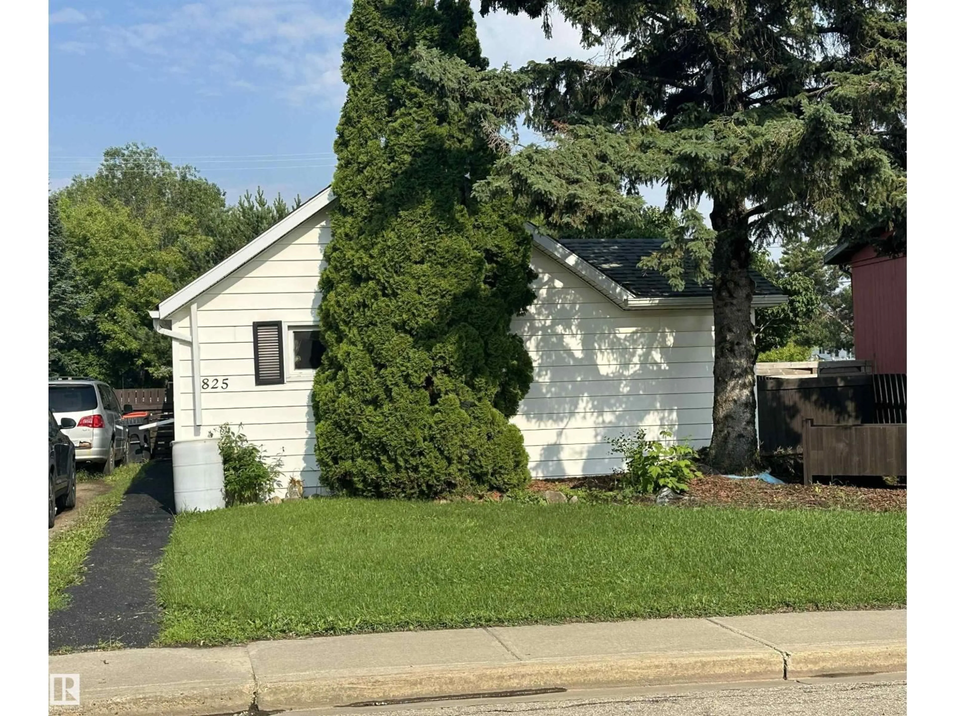 Home with vinyl exterior material, street for 825 2 ST, Thorhild Alberta T0A3J0