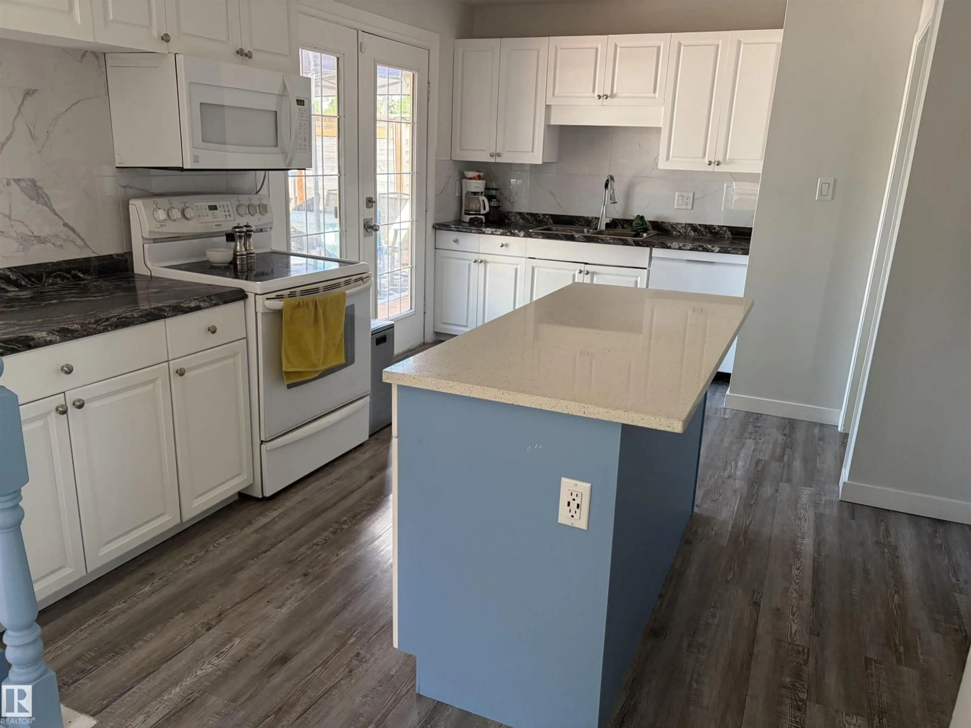 Open concept kitchen, wood/laminate floor for 15922 92 AV, Edmonton Alberta T5R5C6