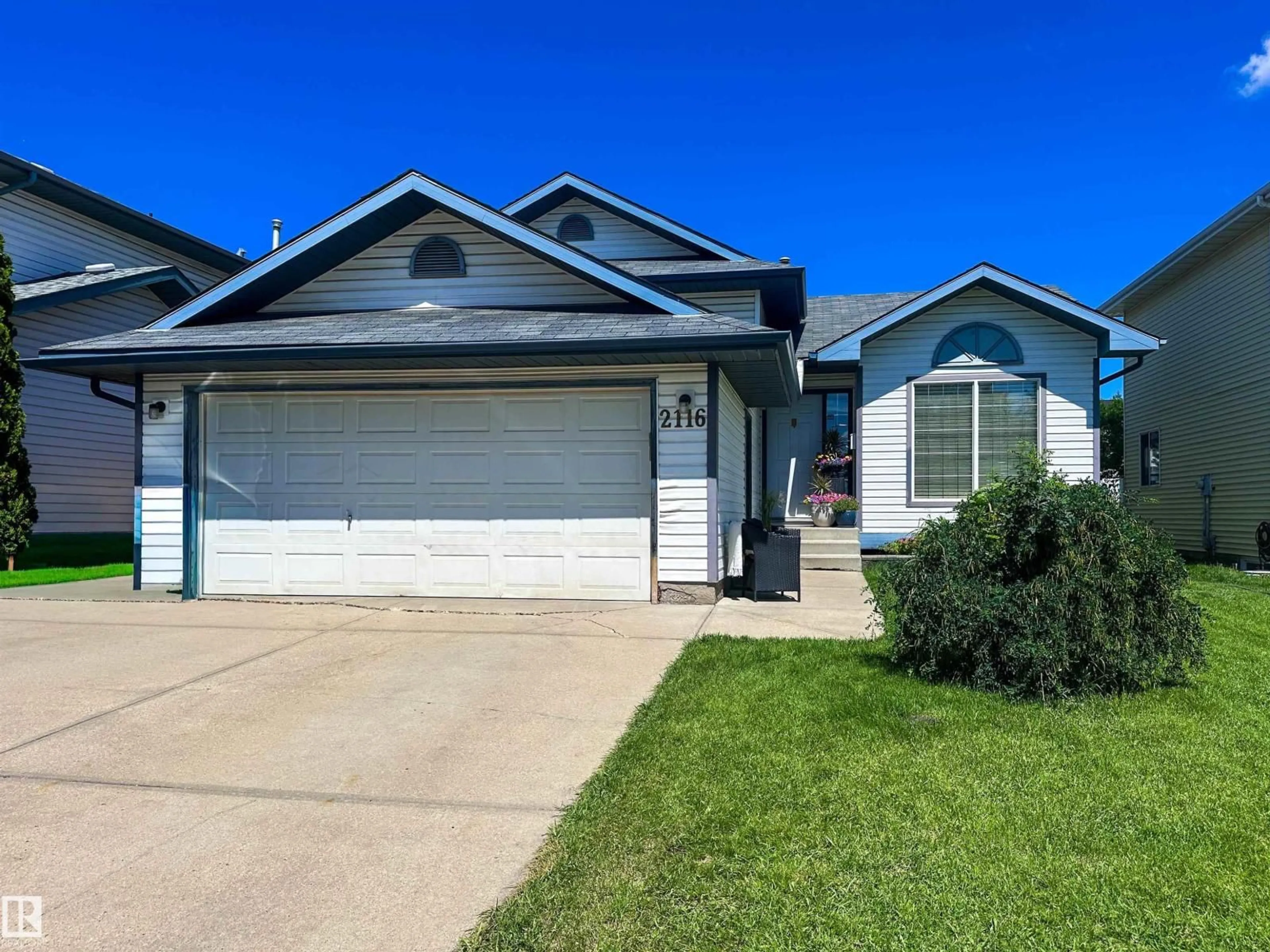 Home with vinyl exterior material, street for 2116 152 AV, Edmonton Alberta T5Y2R6