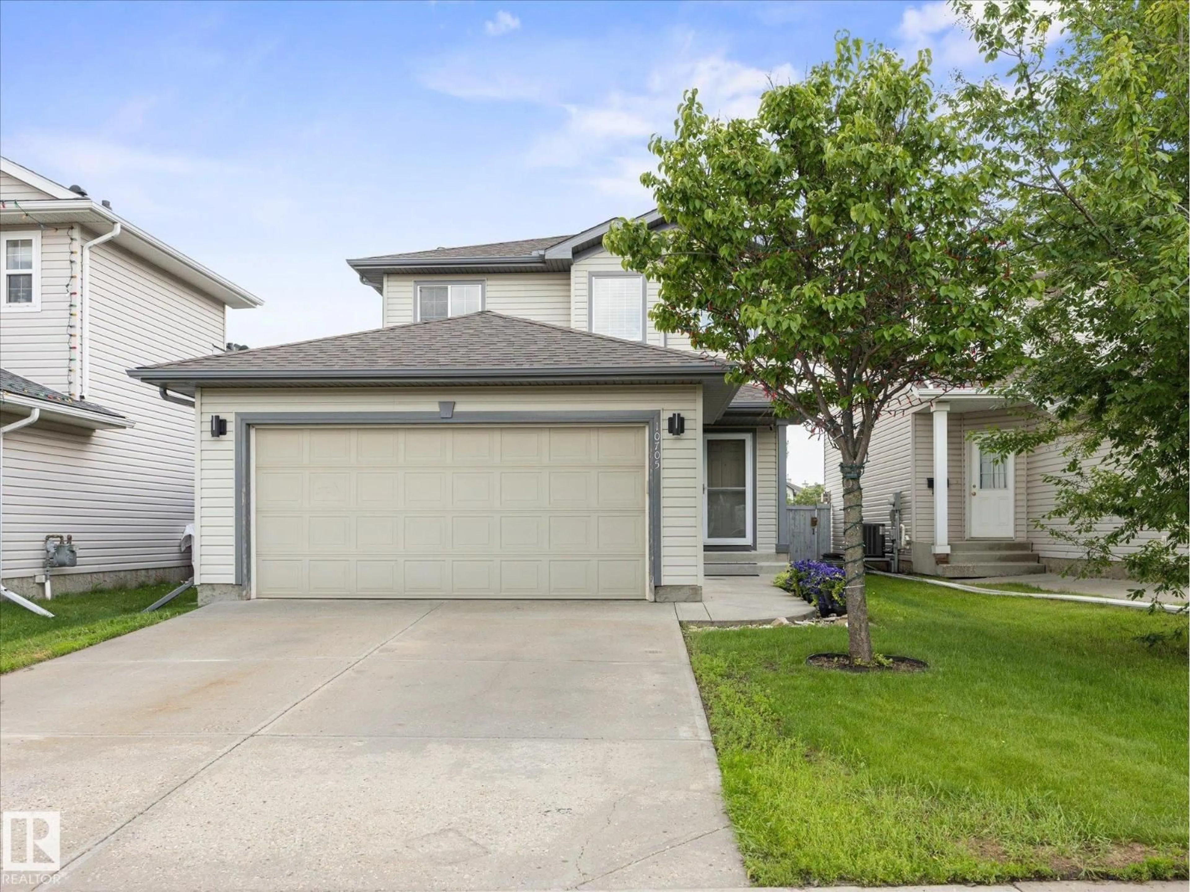 Home with vinyl exterior material, street for NW - 10705 180 AV, Edmonton Alberta T5X6C9