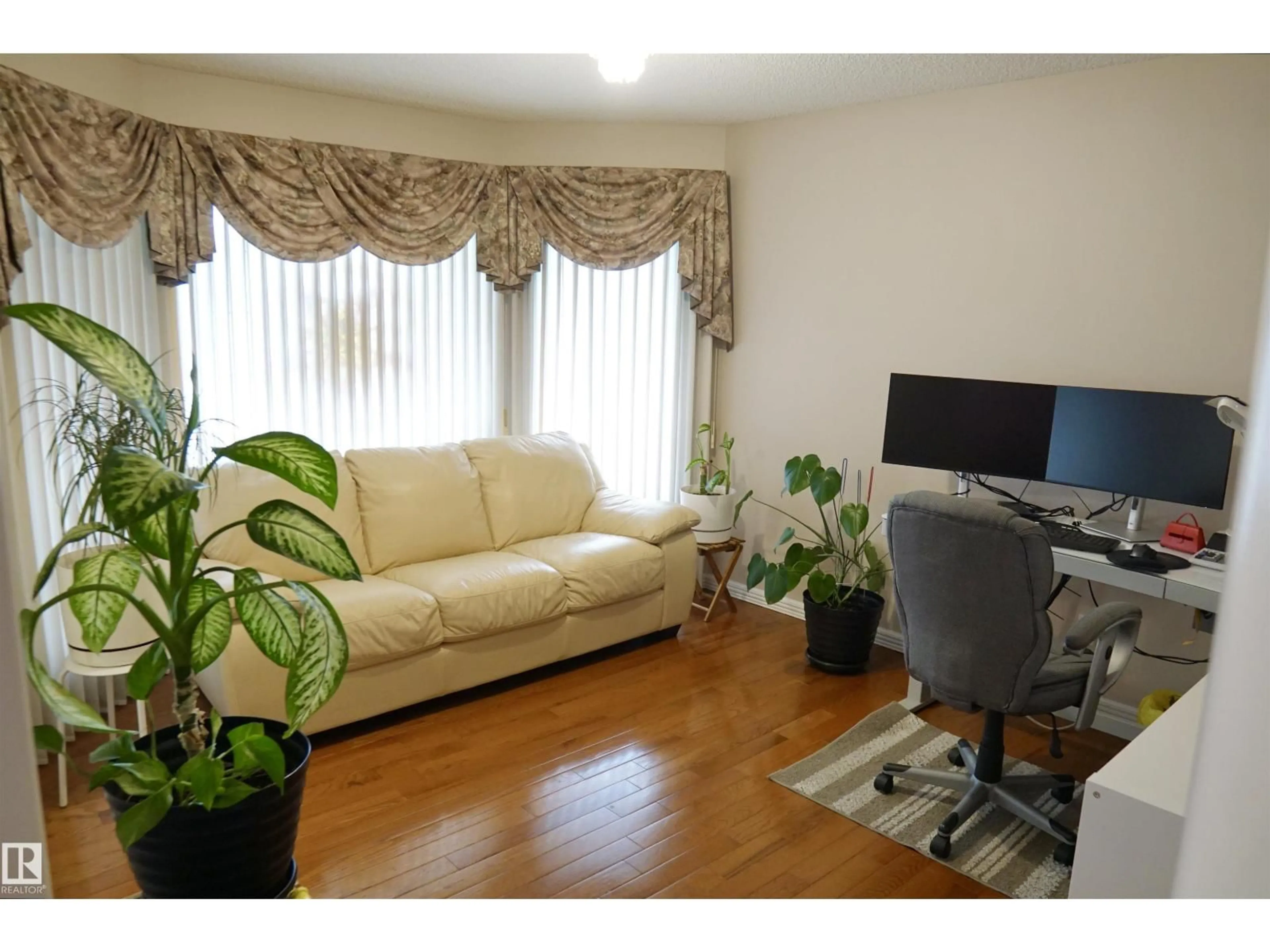 Living room with furniture, wood/laminate floor for 8504 160A AV, Edmonton Alberta T5Z3K2