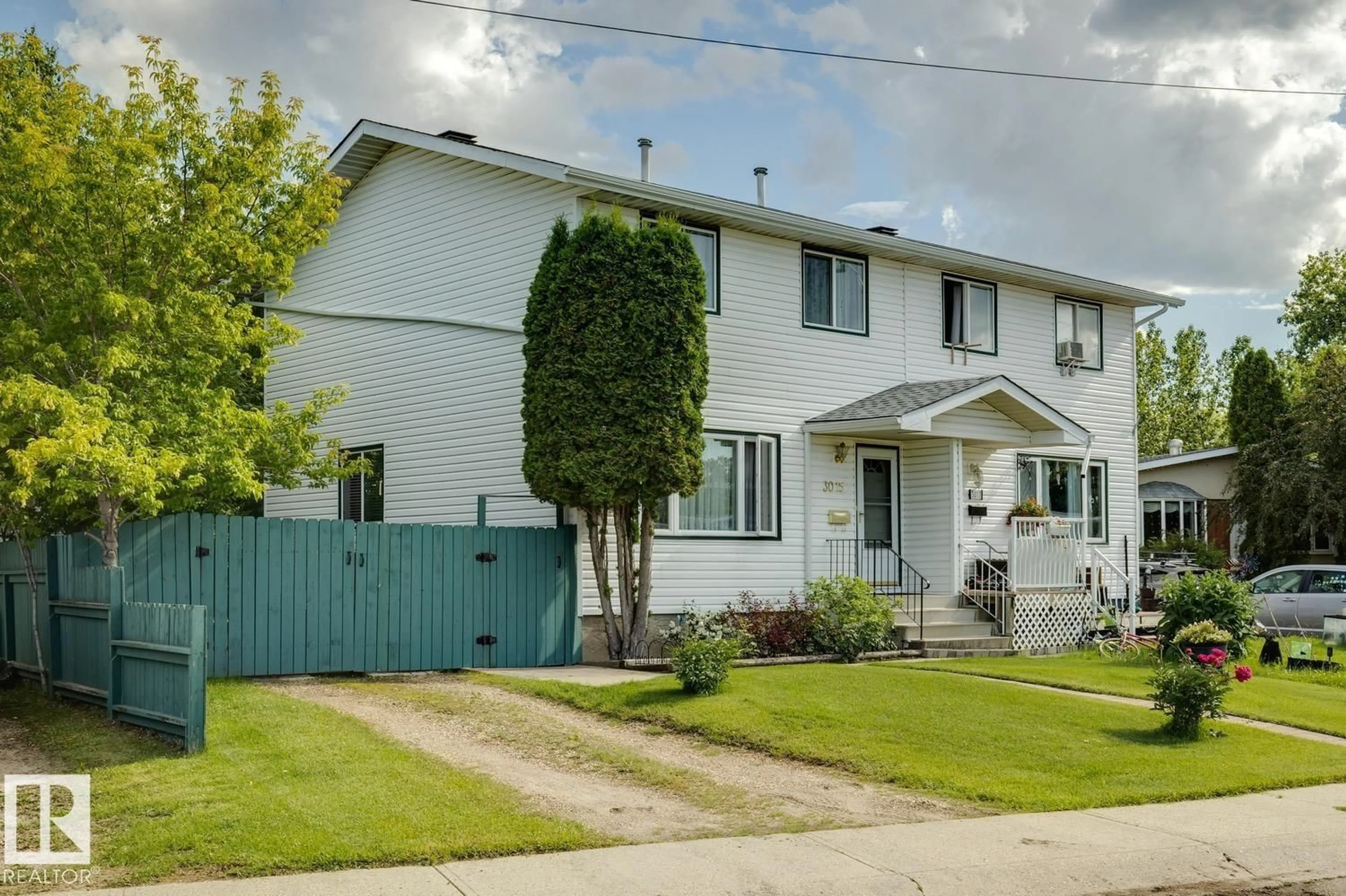 Home with vinyl exterior material, street for NW - 3015 131 AV, Edmonton Alberta T5A2Y9