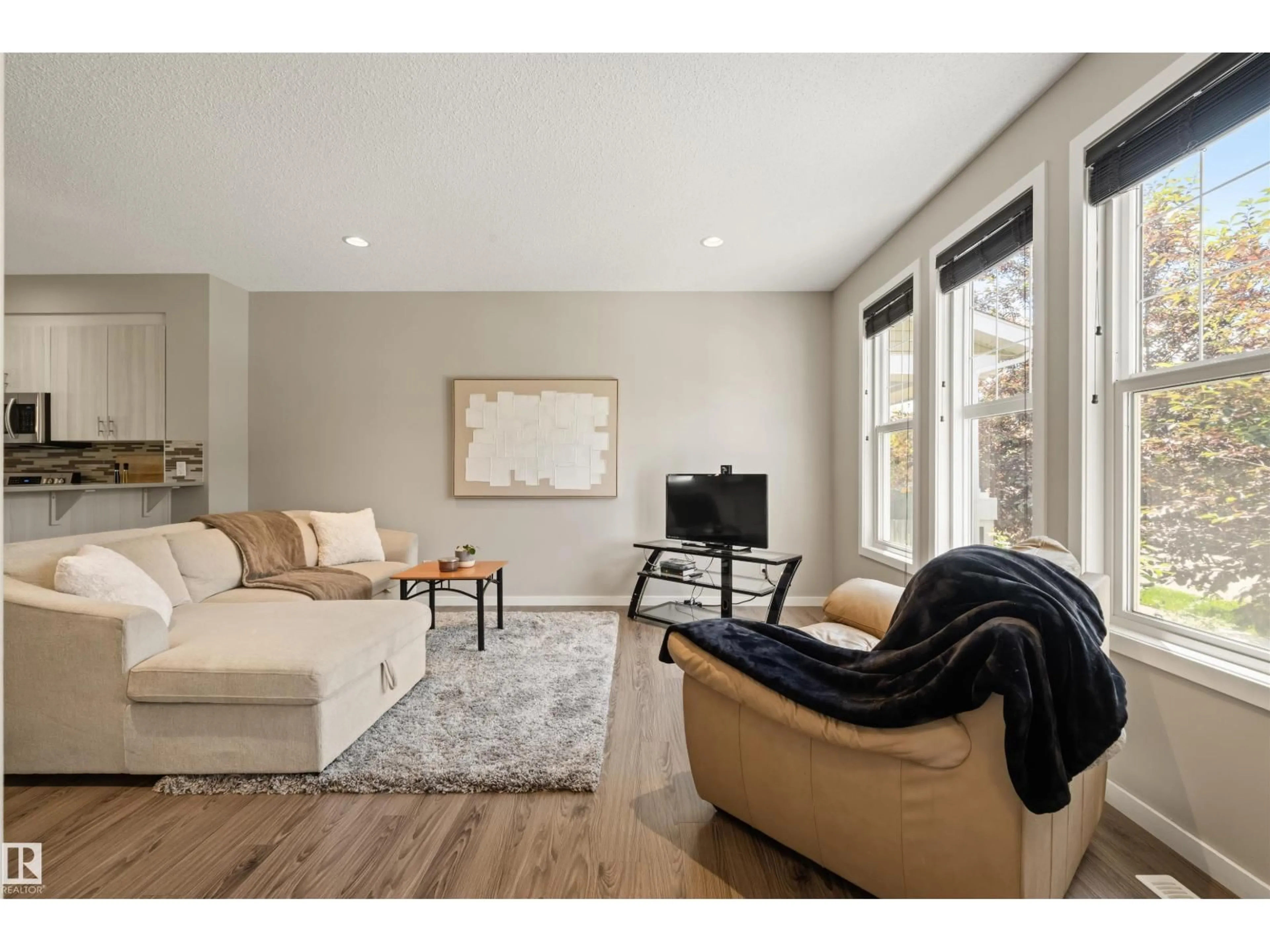 Living room with furniture, wood/laminate floor for SW - 2313 69A ST, Edmonton Alberta T6X1Z3