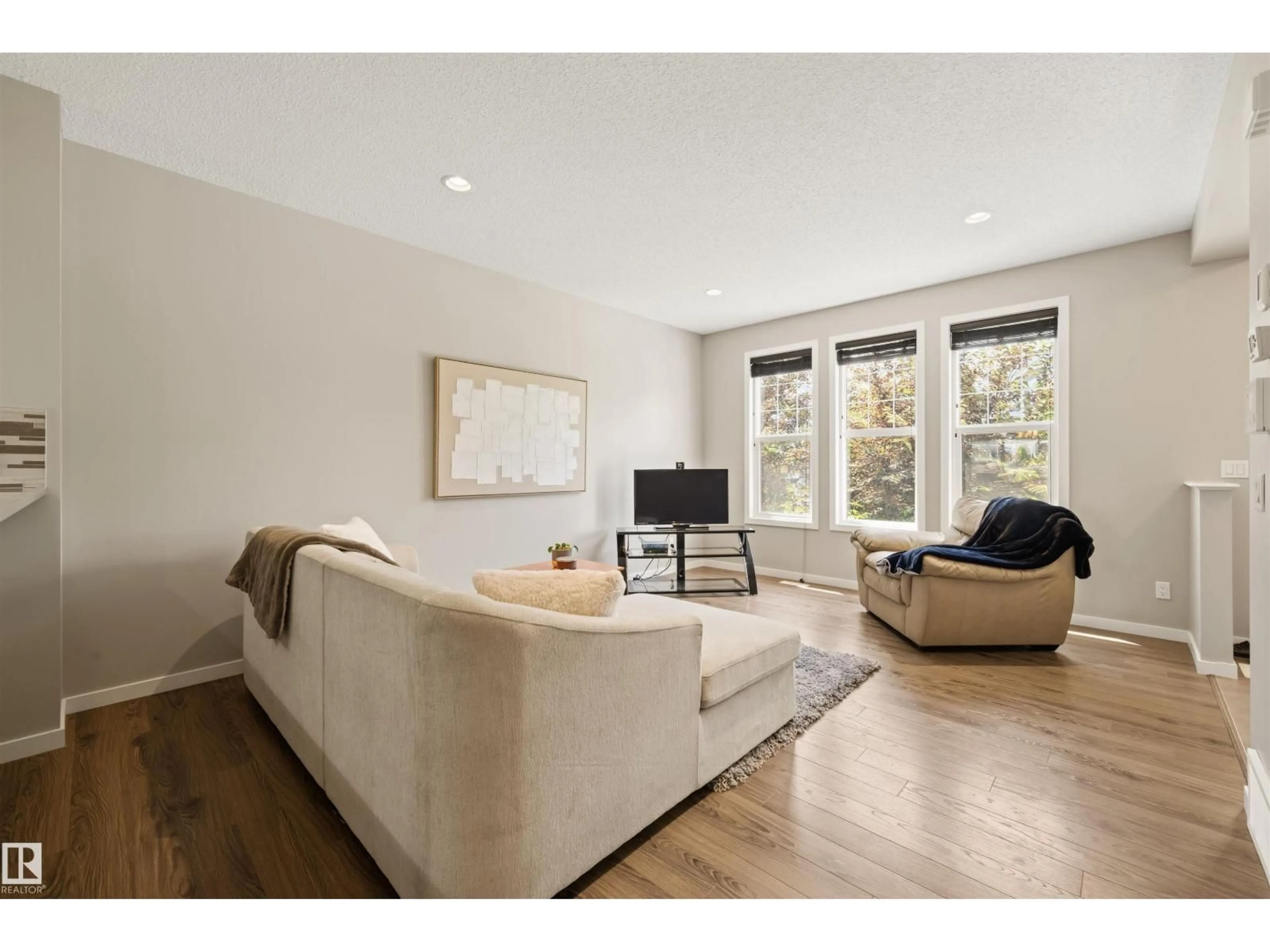 Living room with furniture, wood/laminate floor for SW - 2313 69A ST, Edmonton Alberta T6X1Z3