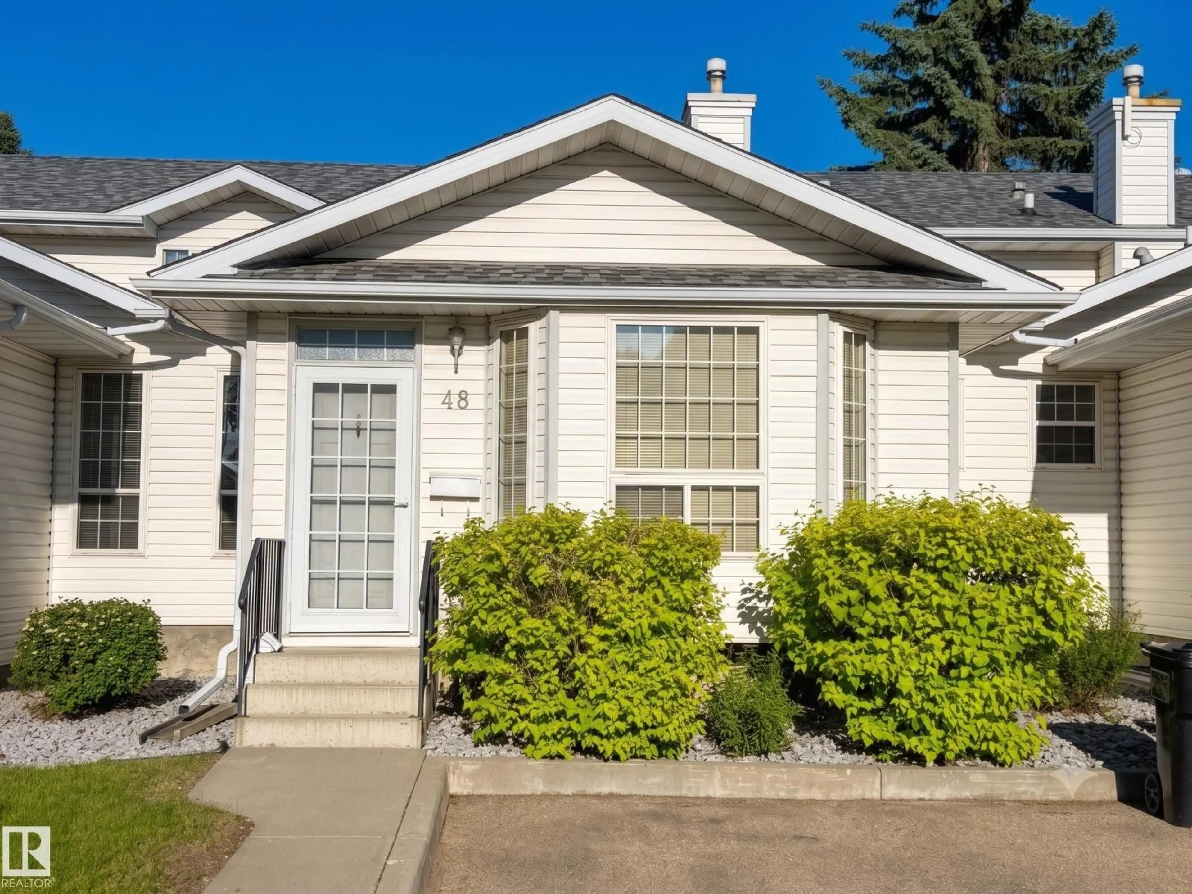 Home with vinyl exterior material, street for 48 3311 58 ST NW, Edmonton Alberta T6L6X3