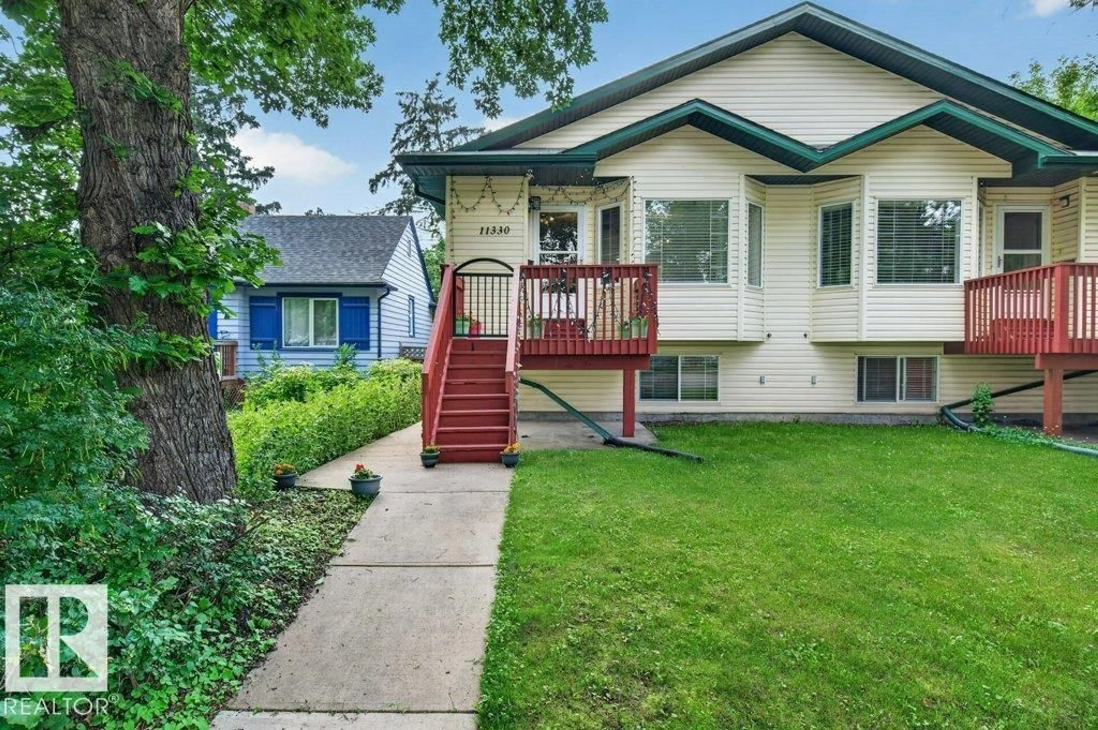 Home with vinyl exterior material, street for NW - 11330 101 ST, Edmonton Alberta T5G2A7