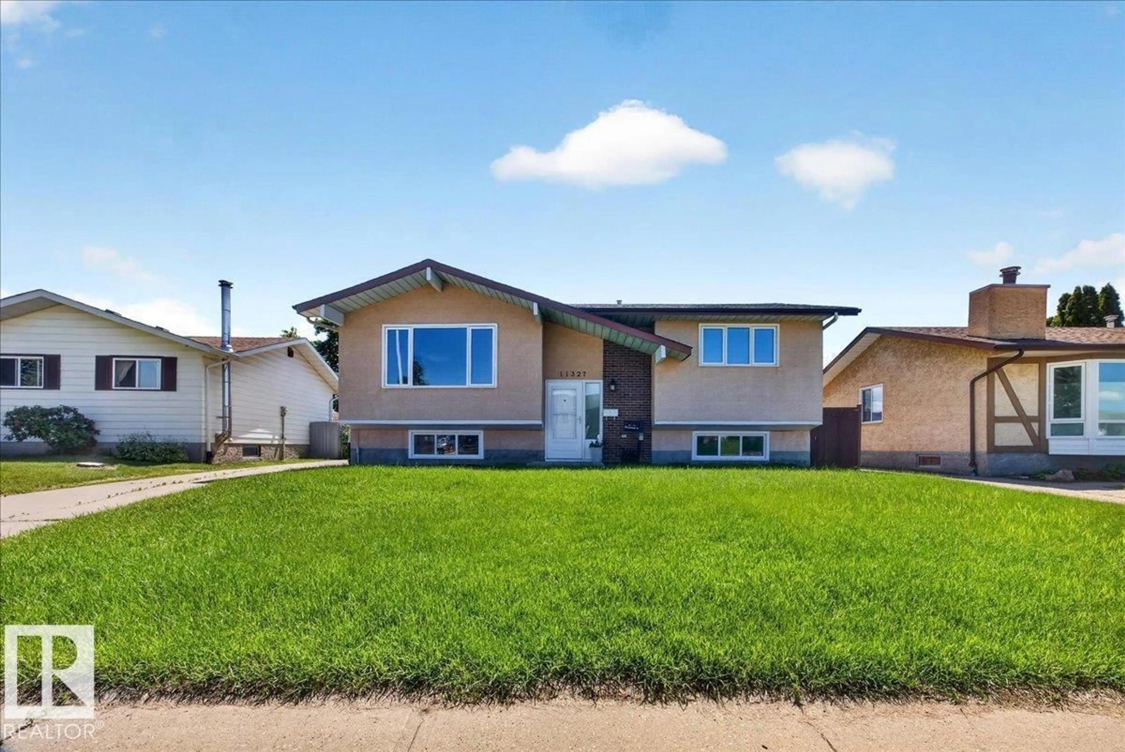 Home with vinyl exterior material, street for 11327 165 AV, Edmonton Alberta T5X3V8