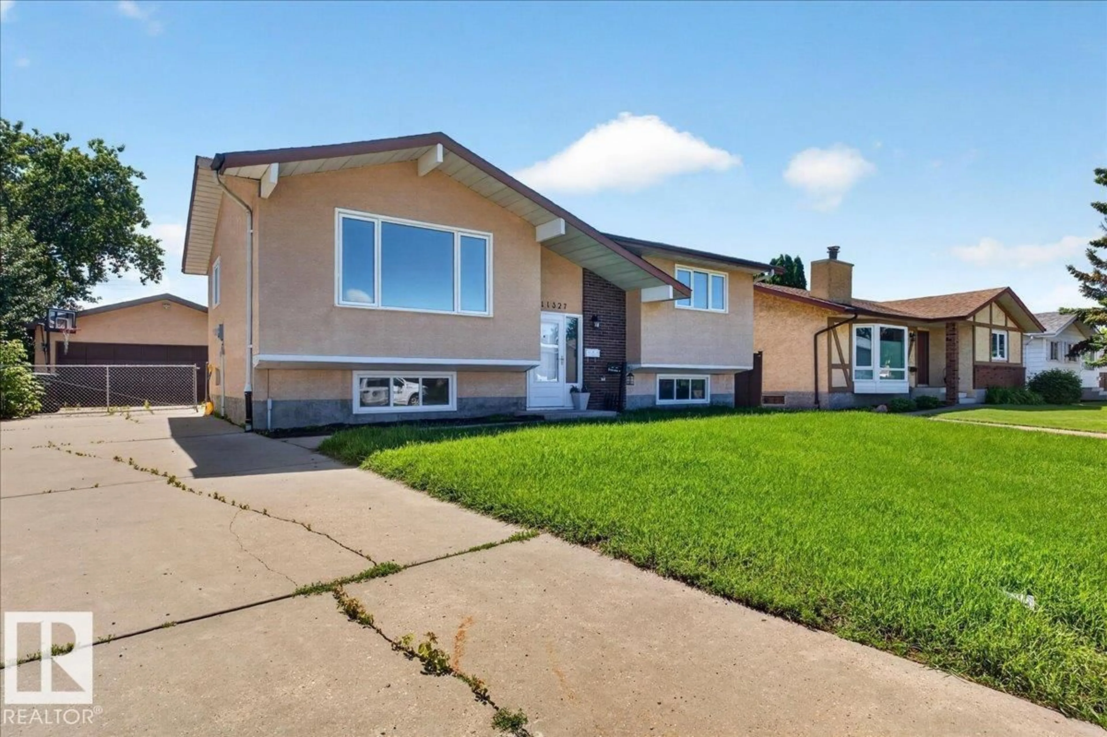 Home with vinyl exterior material, street for 11327 165 AV, Edmonton Alberta T5X3V8