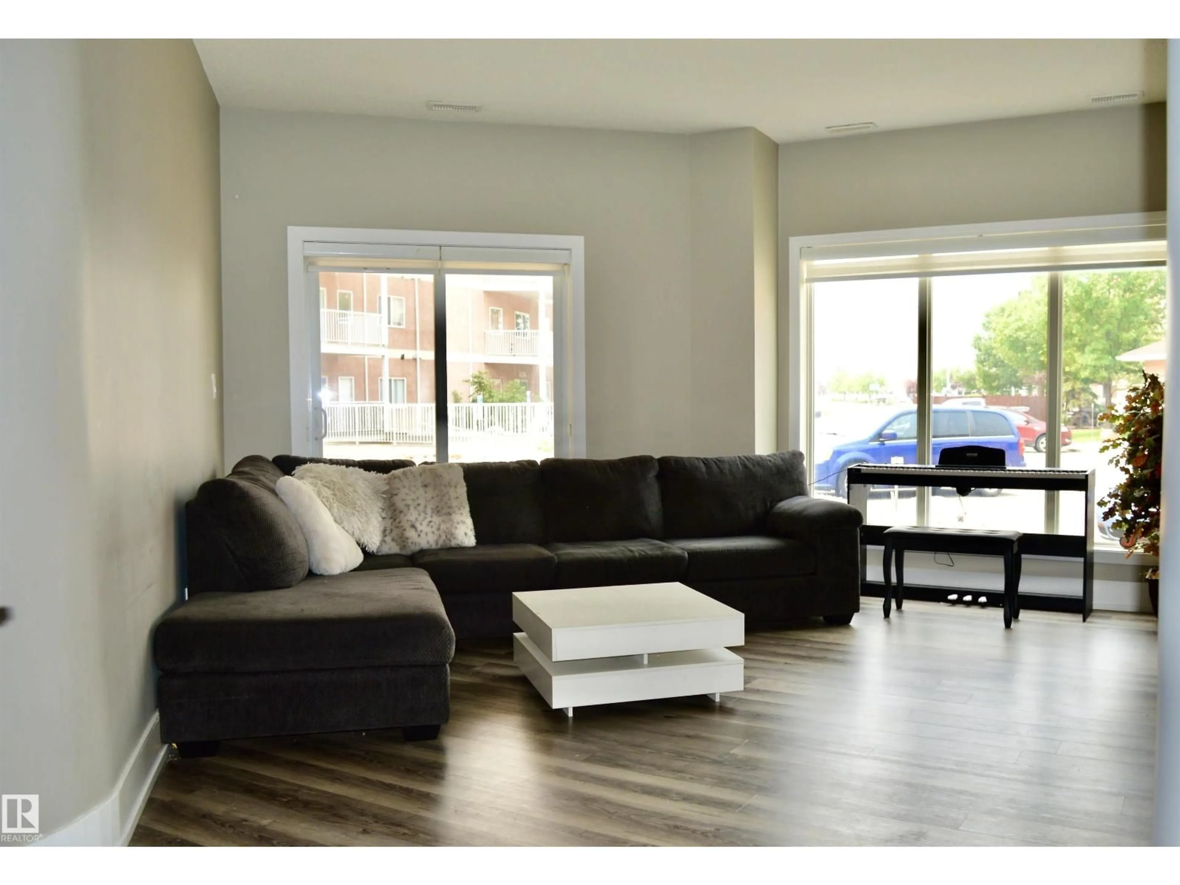 Living room with furniture, wood/laminate floor for #104 - 4312 139 AV, Edmonton Alberta T6T1E7