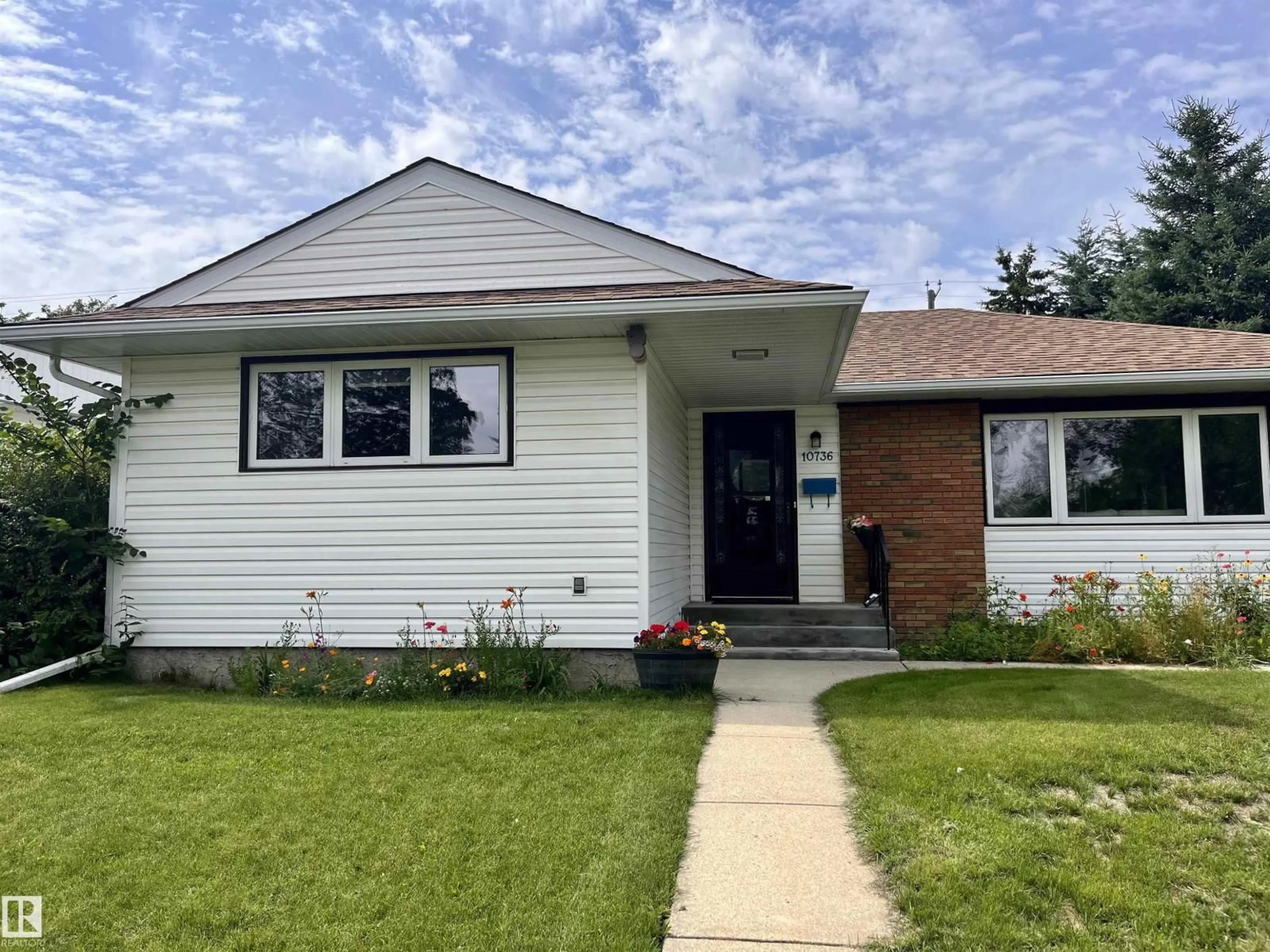 Home with vinyl exterior material, street for 10736 48 ST, Edmonton Alberta T6A2B5