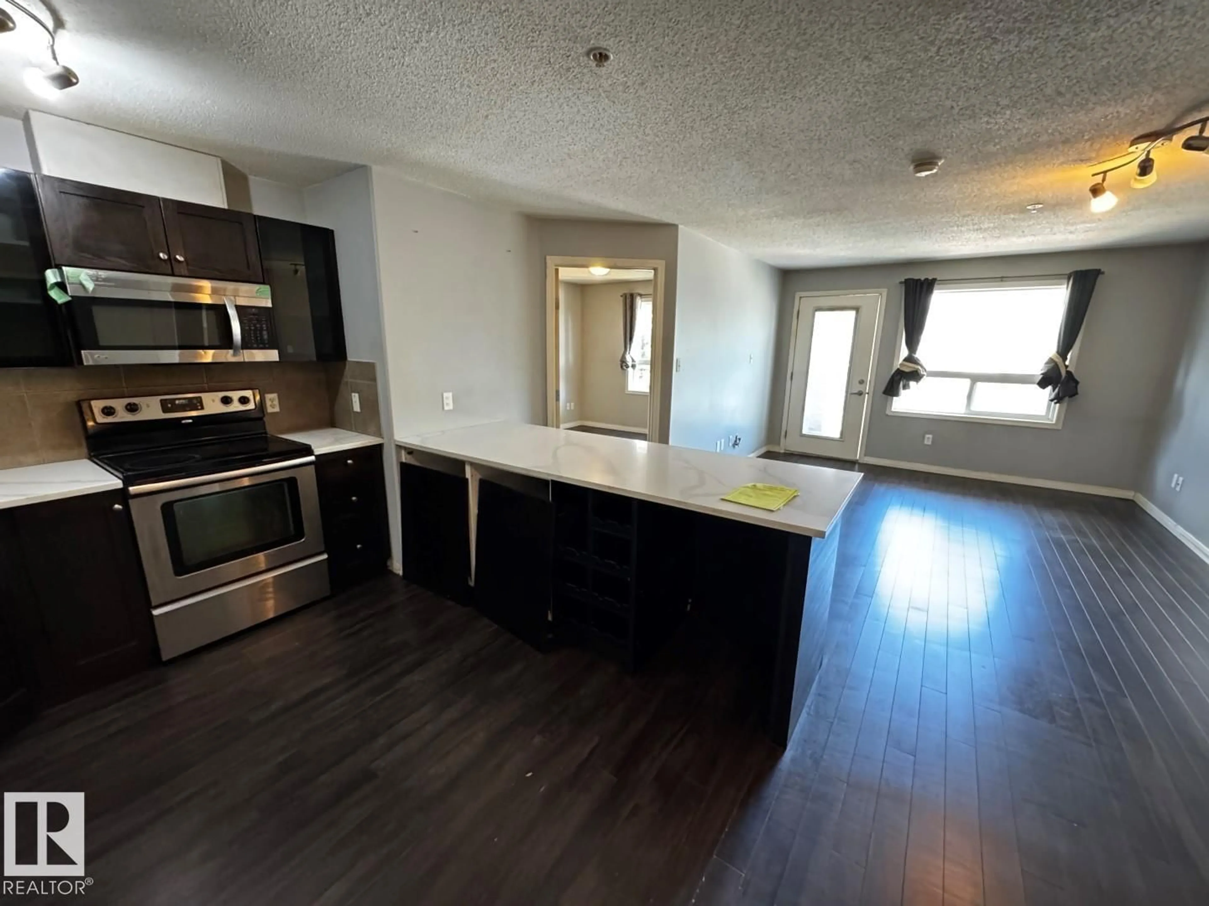Open concept kitchen, wood/laminate floor for #2211 - 2211 SIMSPON DR, Edmonton Alberta T6R0N3