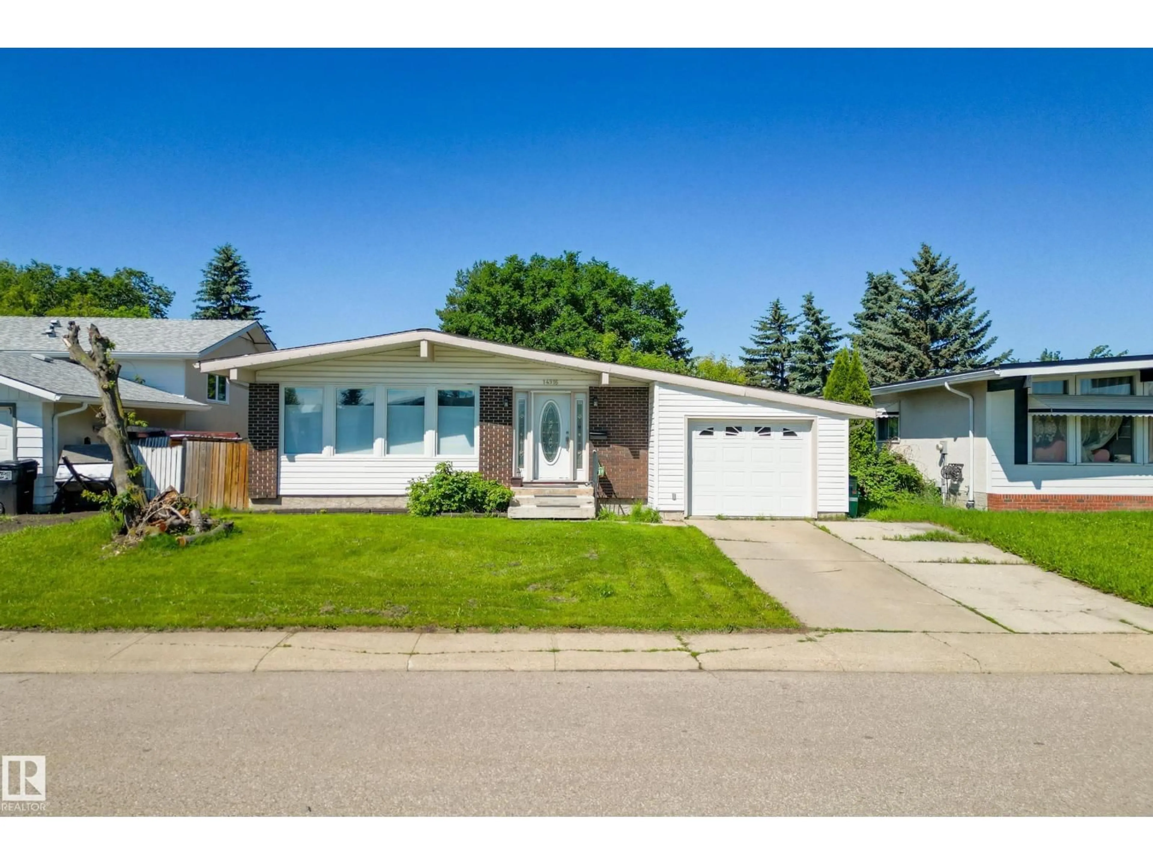 Home with vinyl exterior material, street for 14916 114A ST NW, Edmonton Alberta T5X1H3