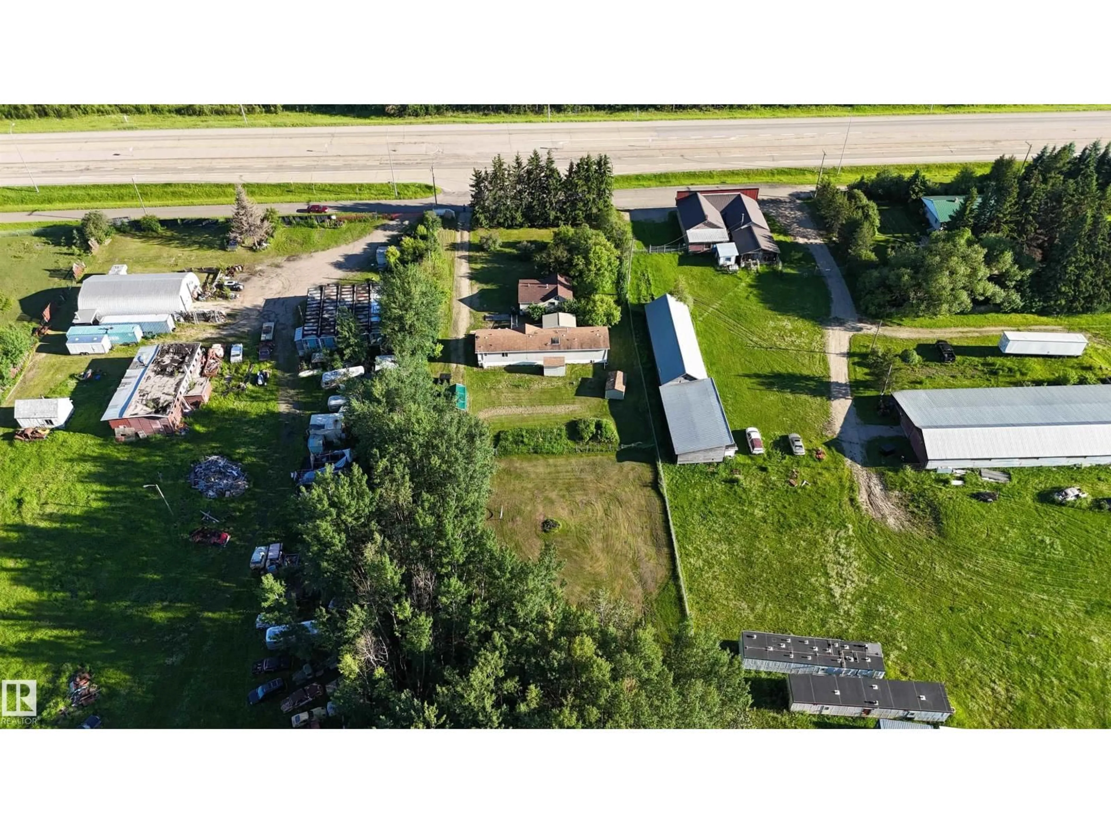 A pic from outside/outdoor area/front of a property/back of a property/a pic from drone, unknown for 6118 HWY 16, Rural Parkland County Alberta T0E0W0