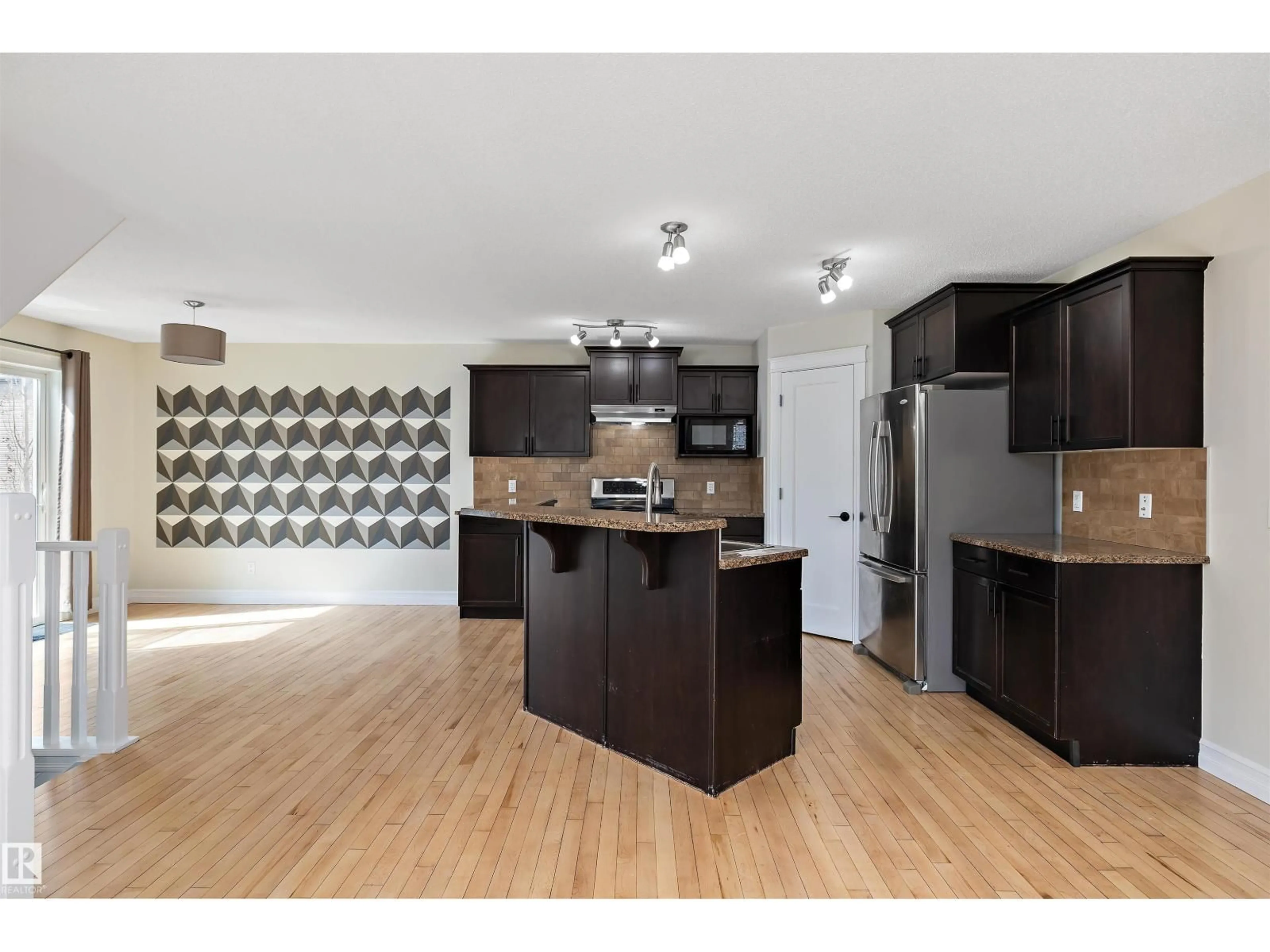 Open concept kitchen, wood/laminate floor for 178 WOODBEND WY, Fort Saskatchewan Alberta T8L4S4