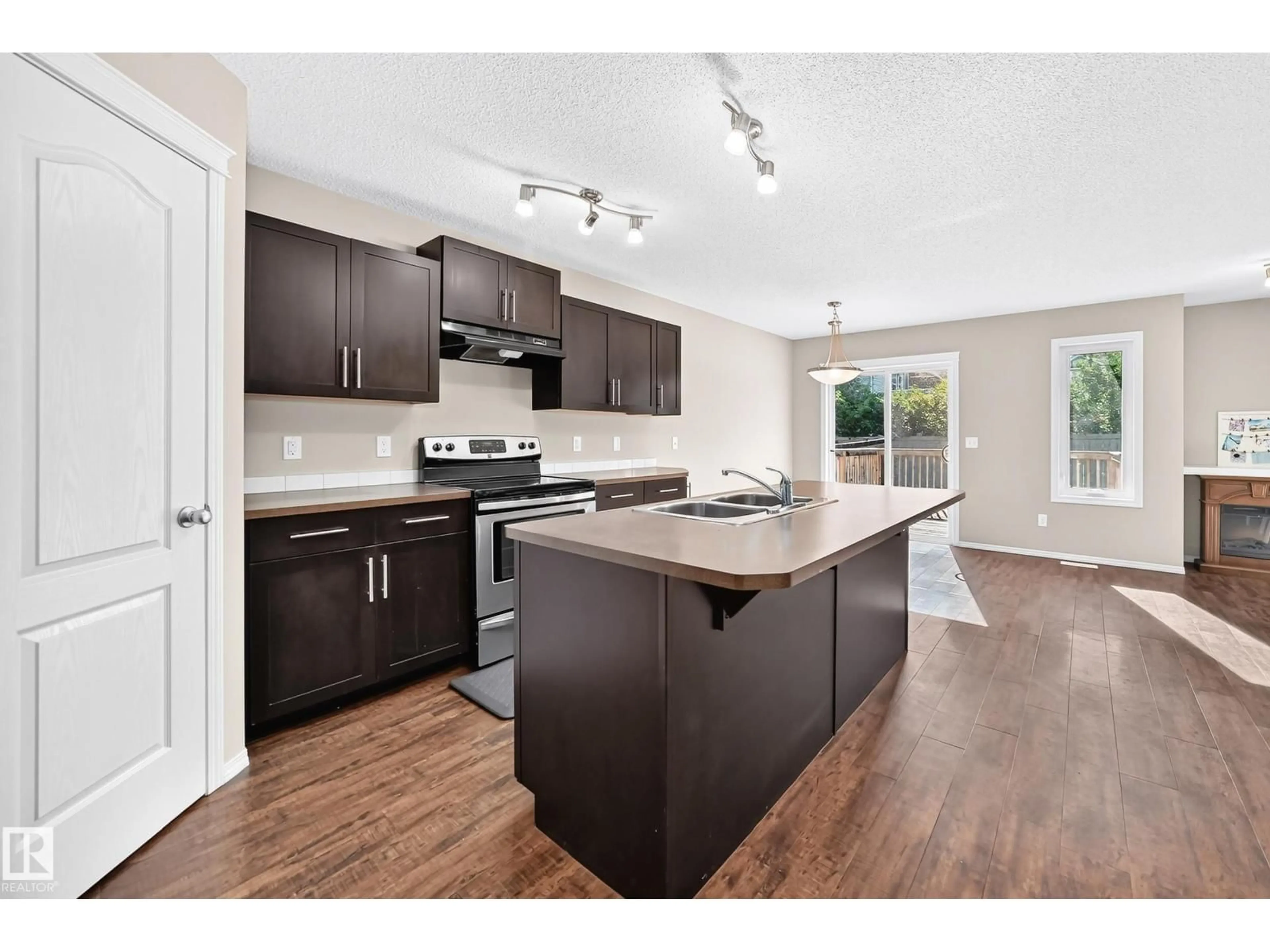 Open concept kitchen, wood/laminate floor for 1806 RUTHERFORD RD, Edmonton Alberta T6W2K6