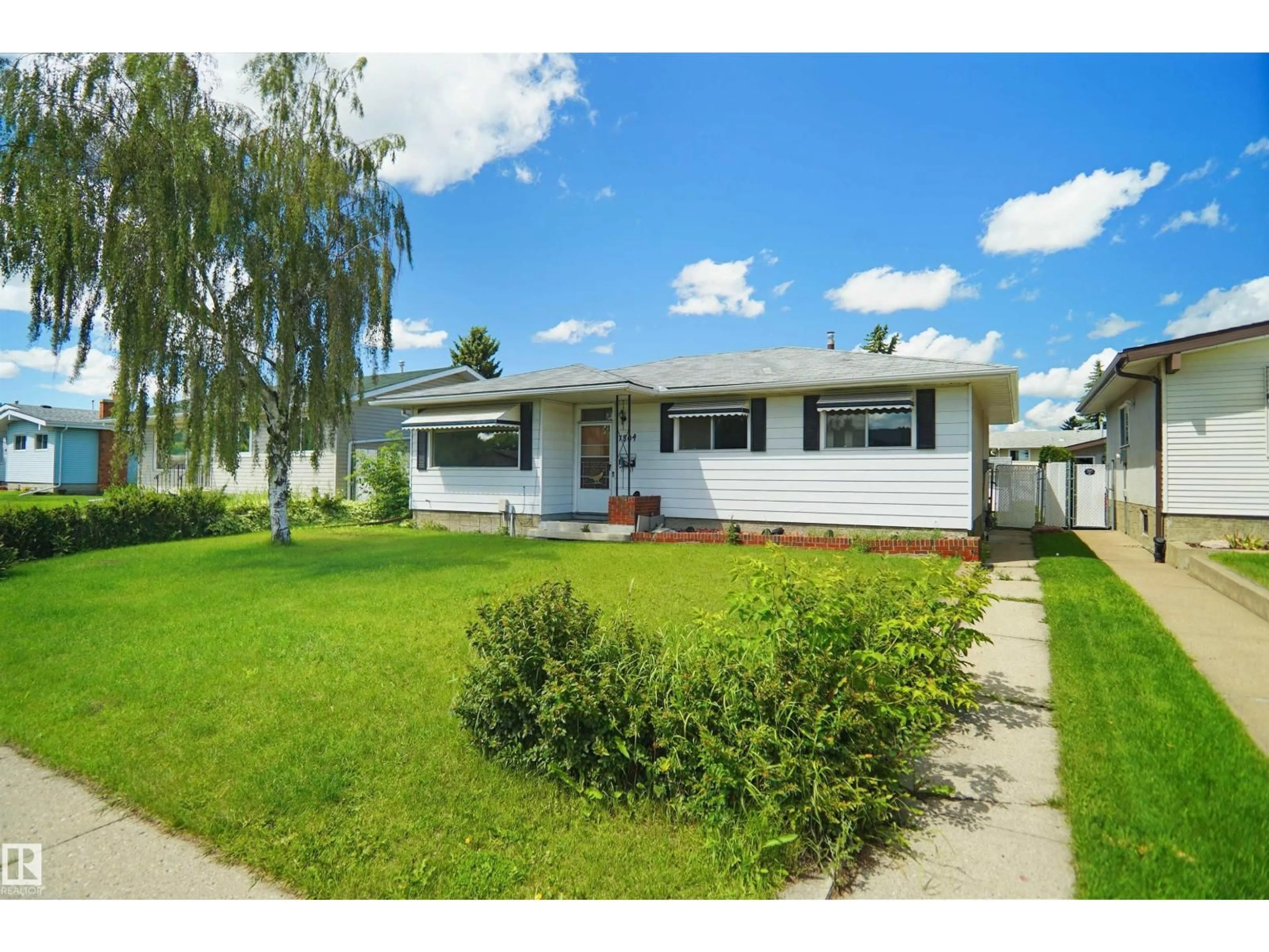 Home with vinyl exterior material, street for 7804 143 AV, Edmonton Alberta T5C2R1